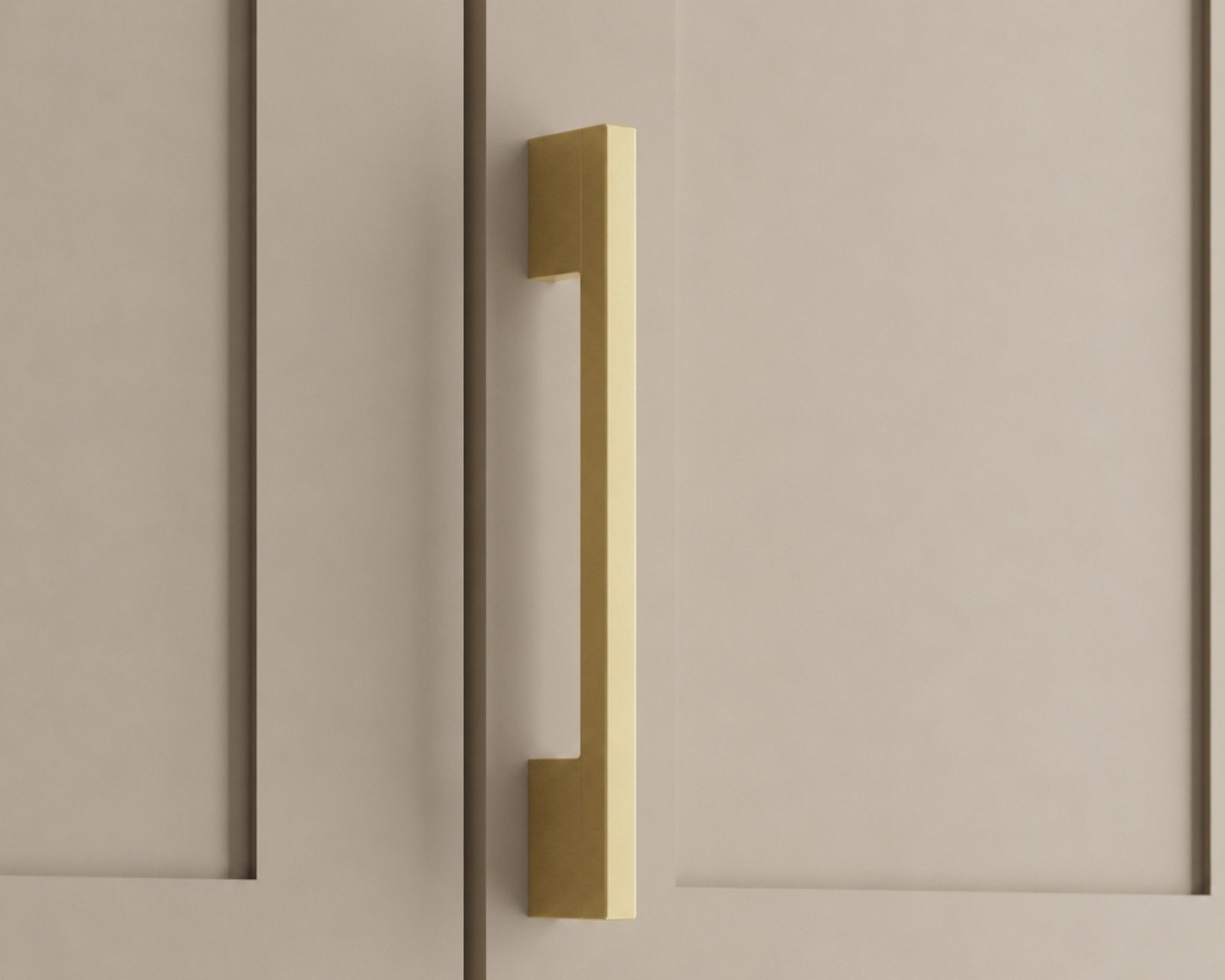 Maddison brass cabinet pull on a beige cabinet