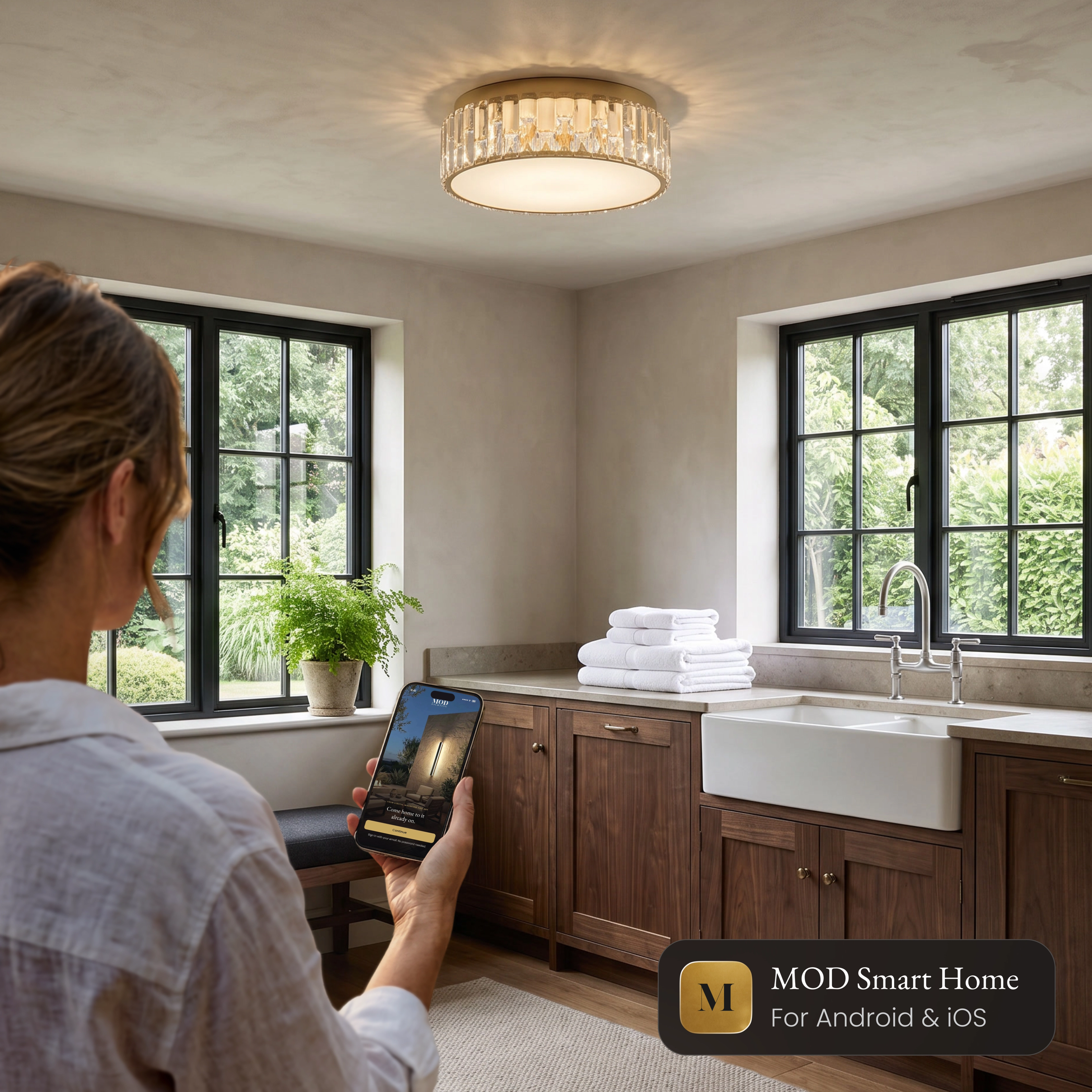 Elara Smart crystal flush mount ceiling light in a kitchen, controlled from the MOD Smart Home app on a phone