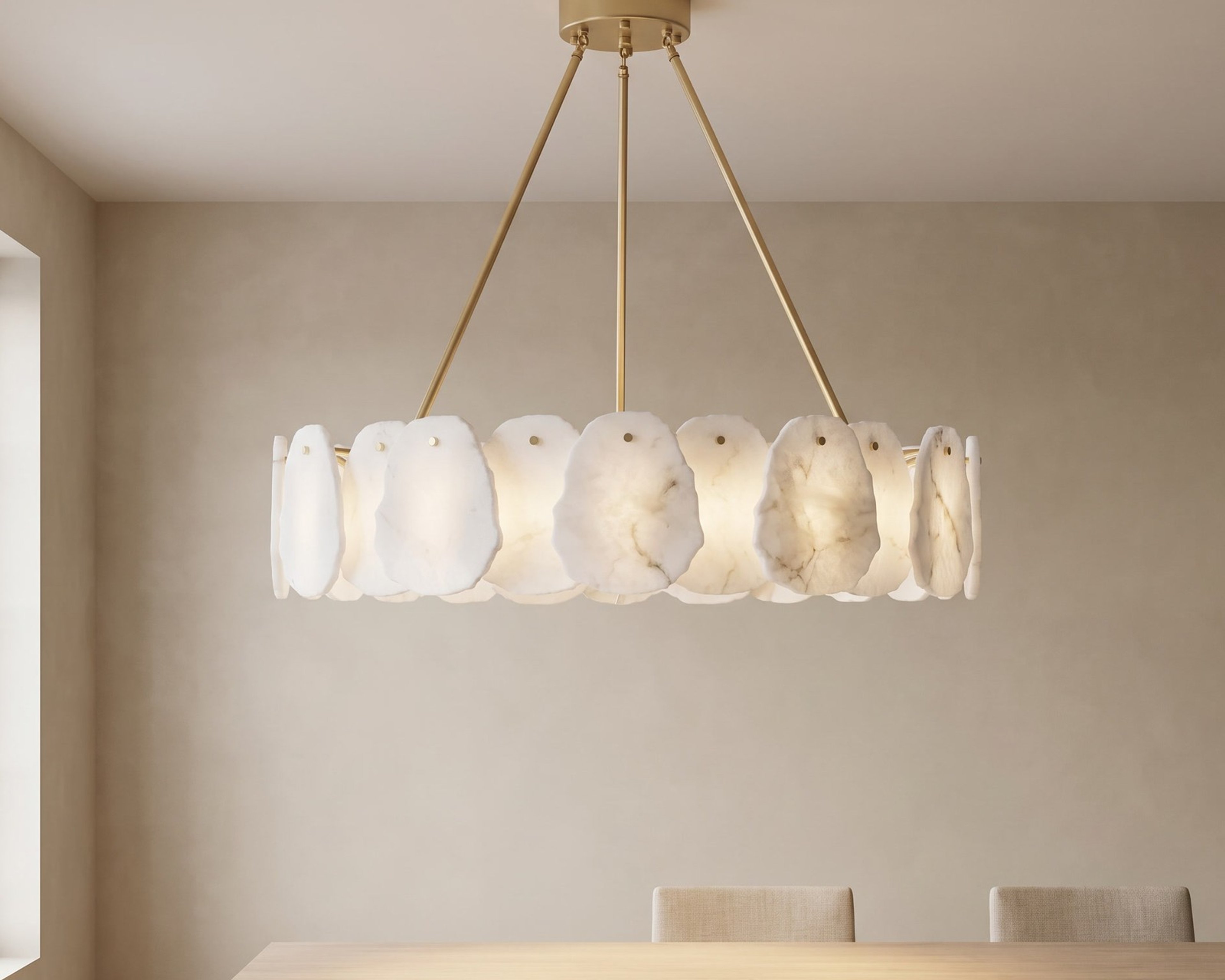 Alba smart chandelier, alabaster discs on brass, lit warm above a dining table