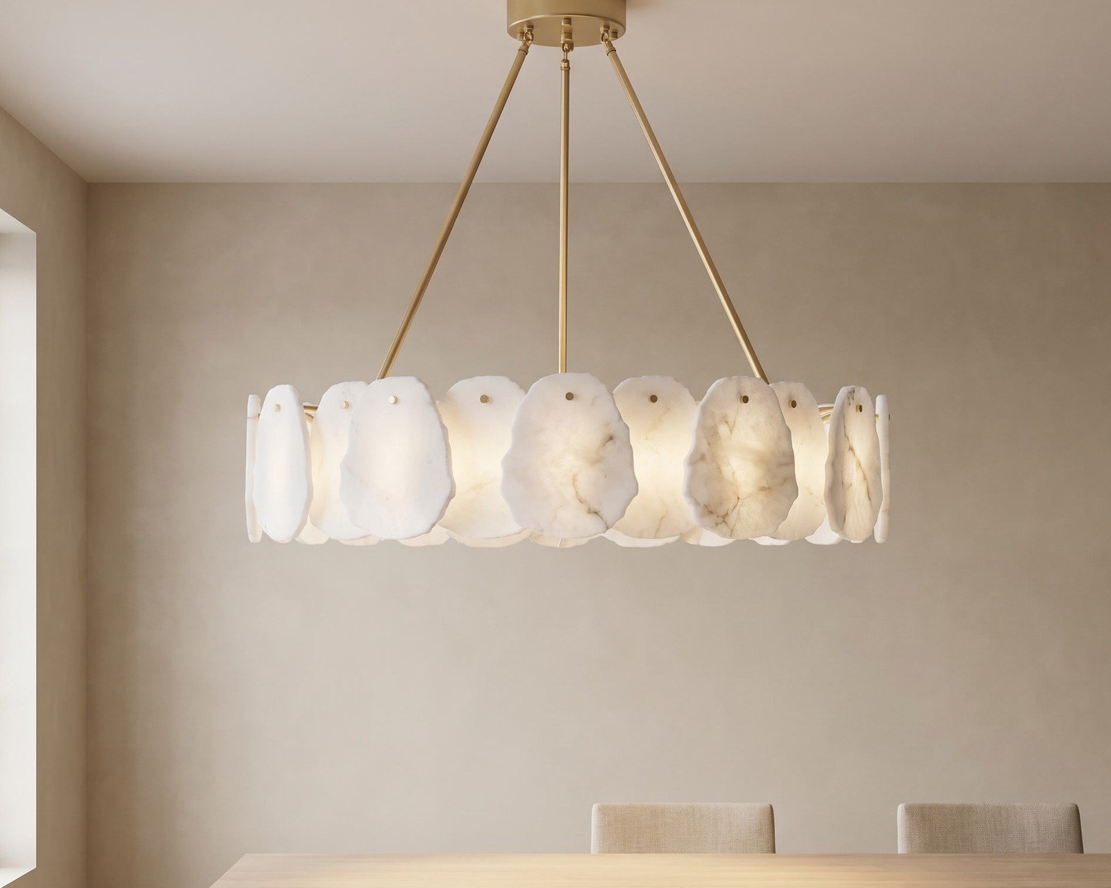 Alba smart chandelier, alabaster discs on brass, lit warm above a dining table