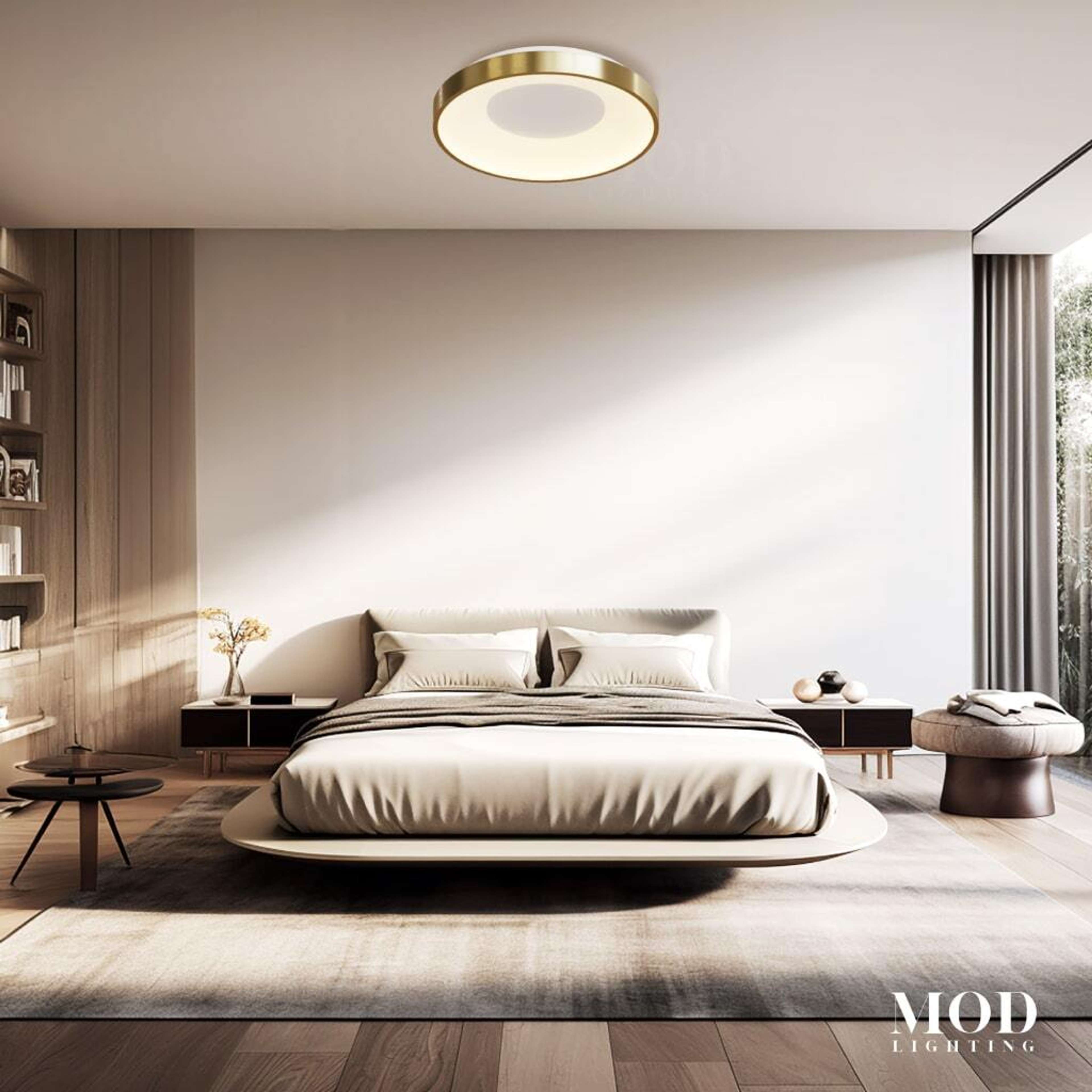 Bryce brushed-gold round LED flush-mount ceiling light glowing warm white above a minimalist bedroom