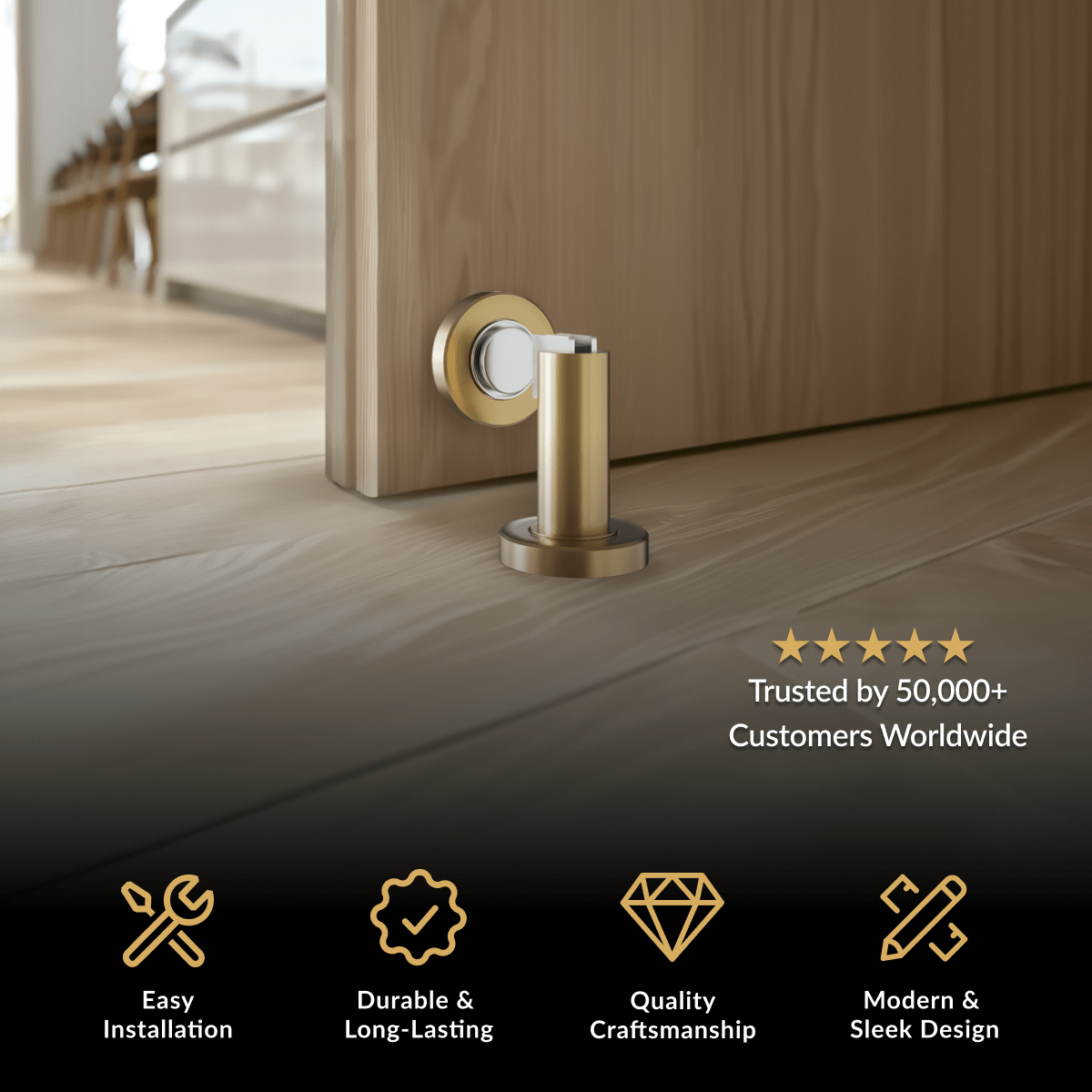 Avi Door Stop in brushed gold, floor-mounted magnetic cylinder catching a wood door on light oak flooring