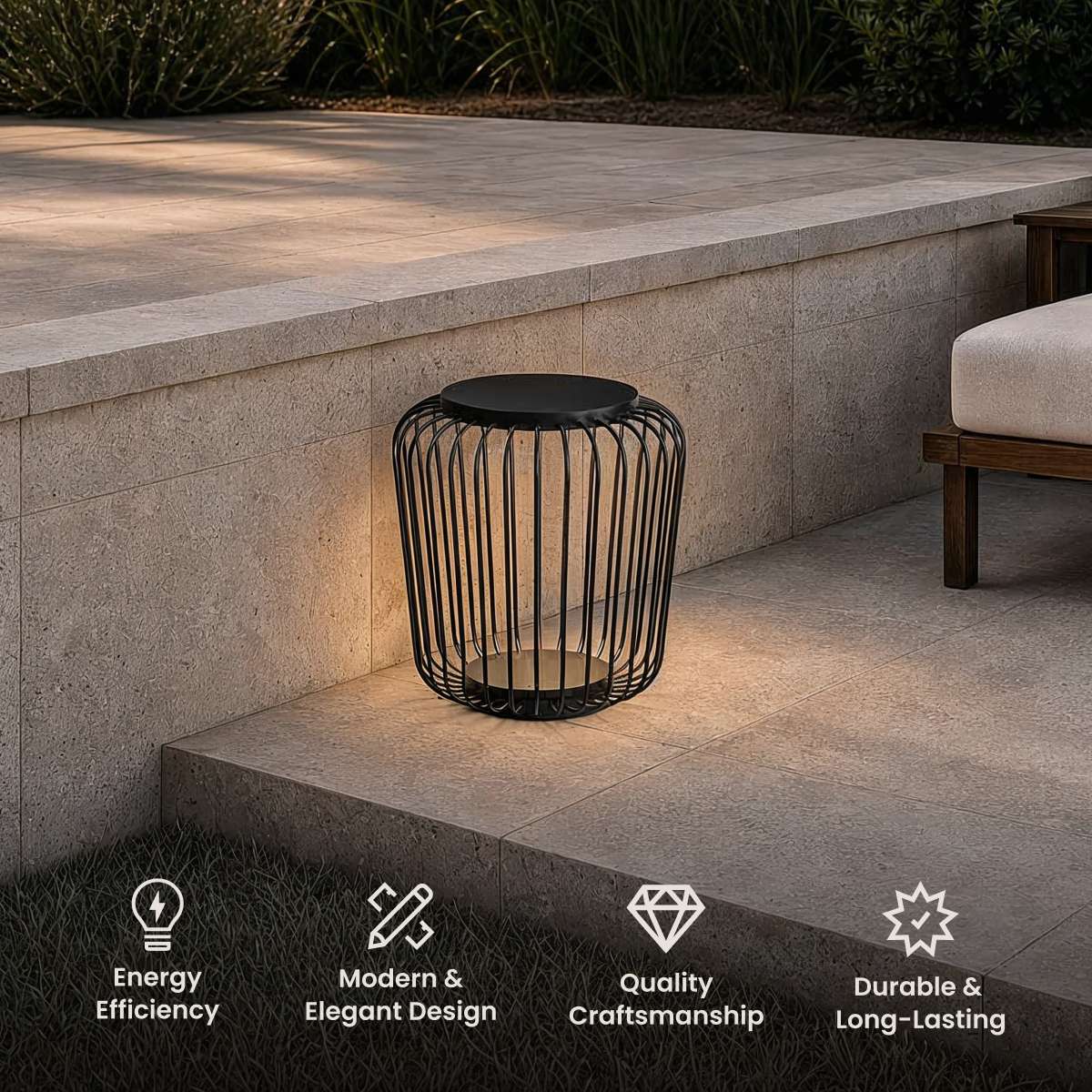 Cedar black wire-cage lantern on a stone step by an outdoor lounge, with energy, design and durability icons