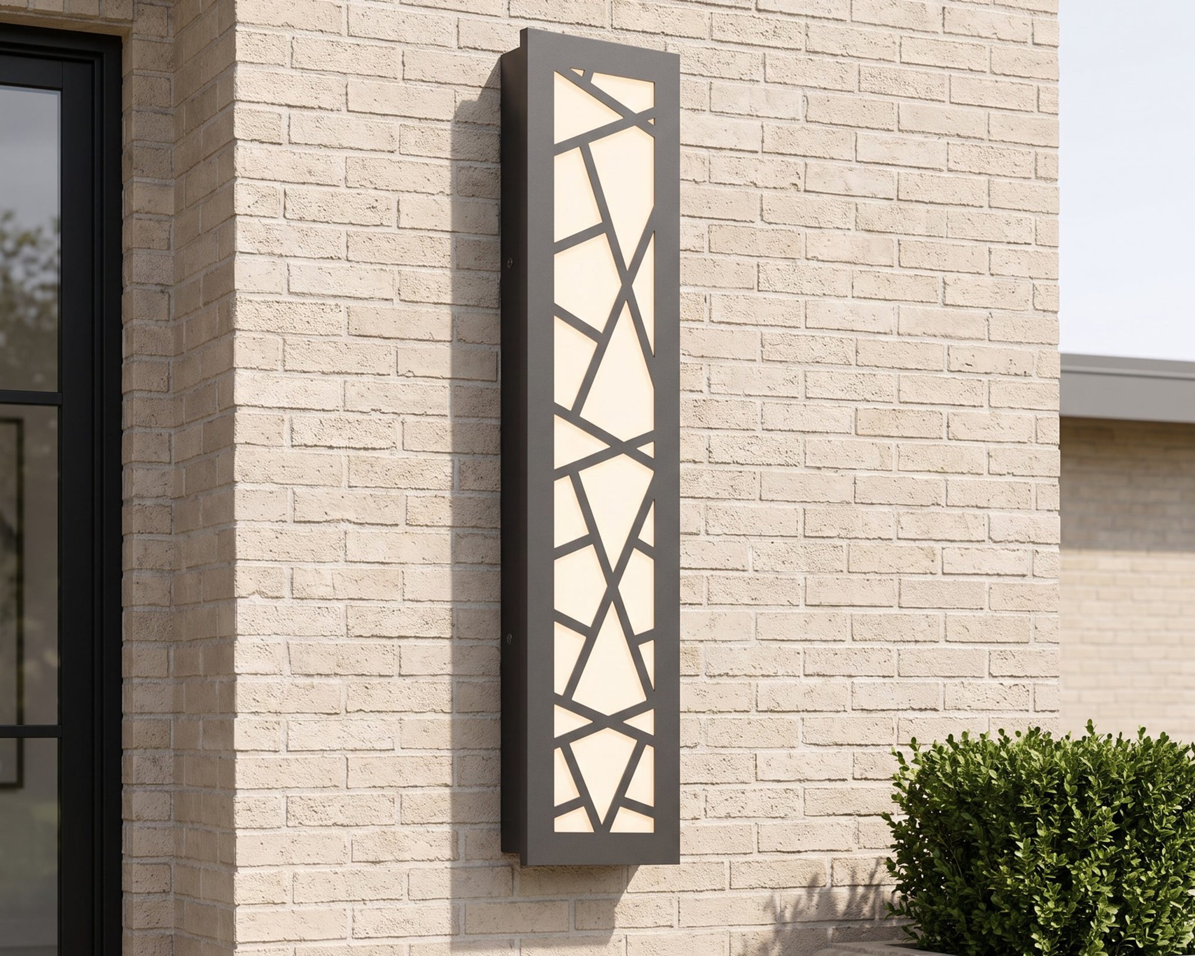 Harper, a linear lattice wall light, on a brick facade