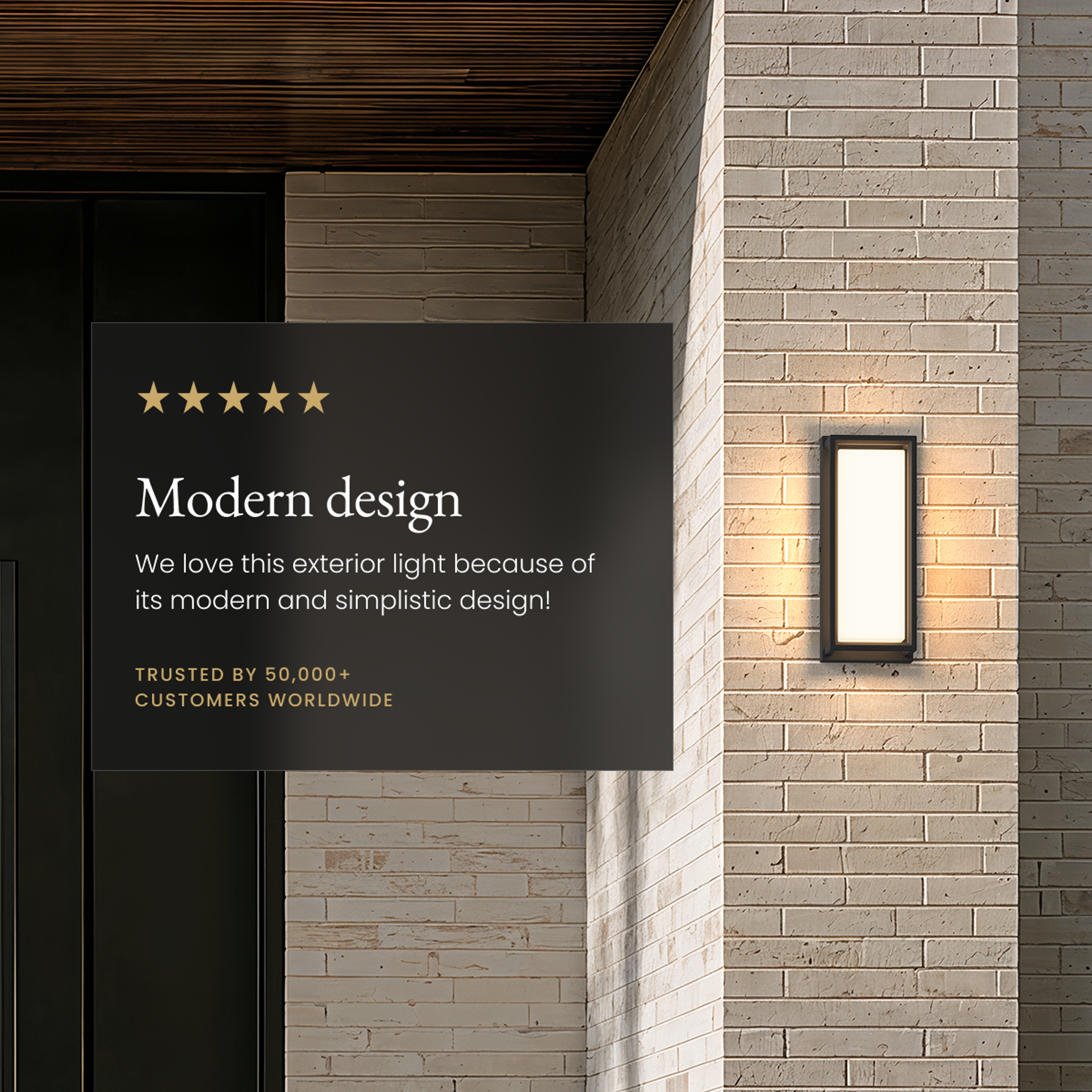 Hollis black square outdoor sconce, frosted-panel glow on a brick wall beside a five-star review card