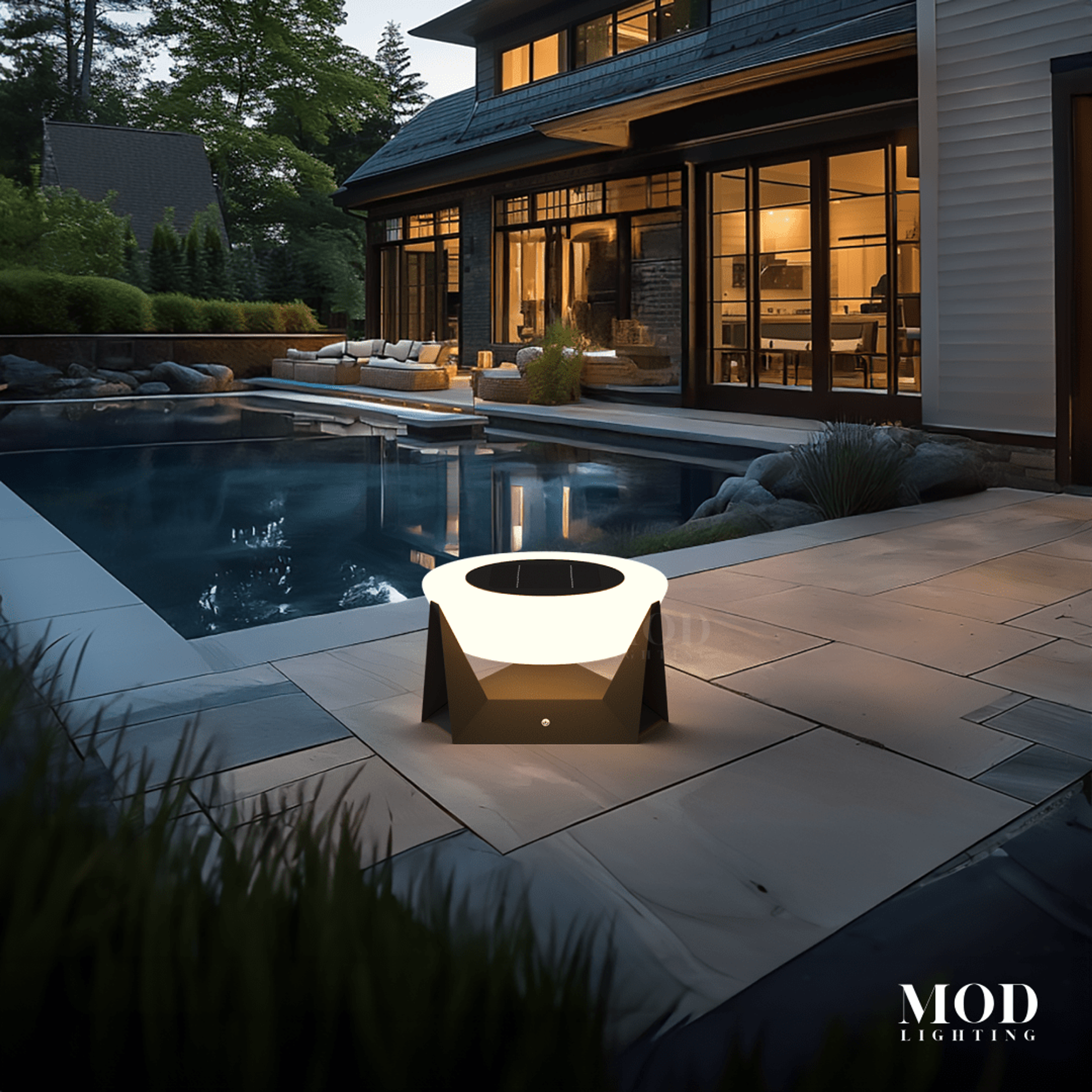 Skye solar table lamp with black frame and frosted glowing shade on a poolside patio at dusk