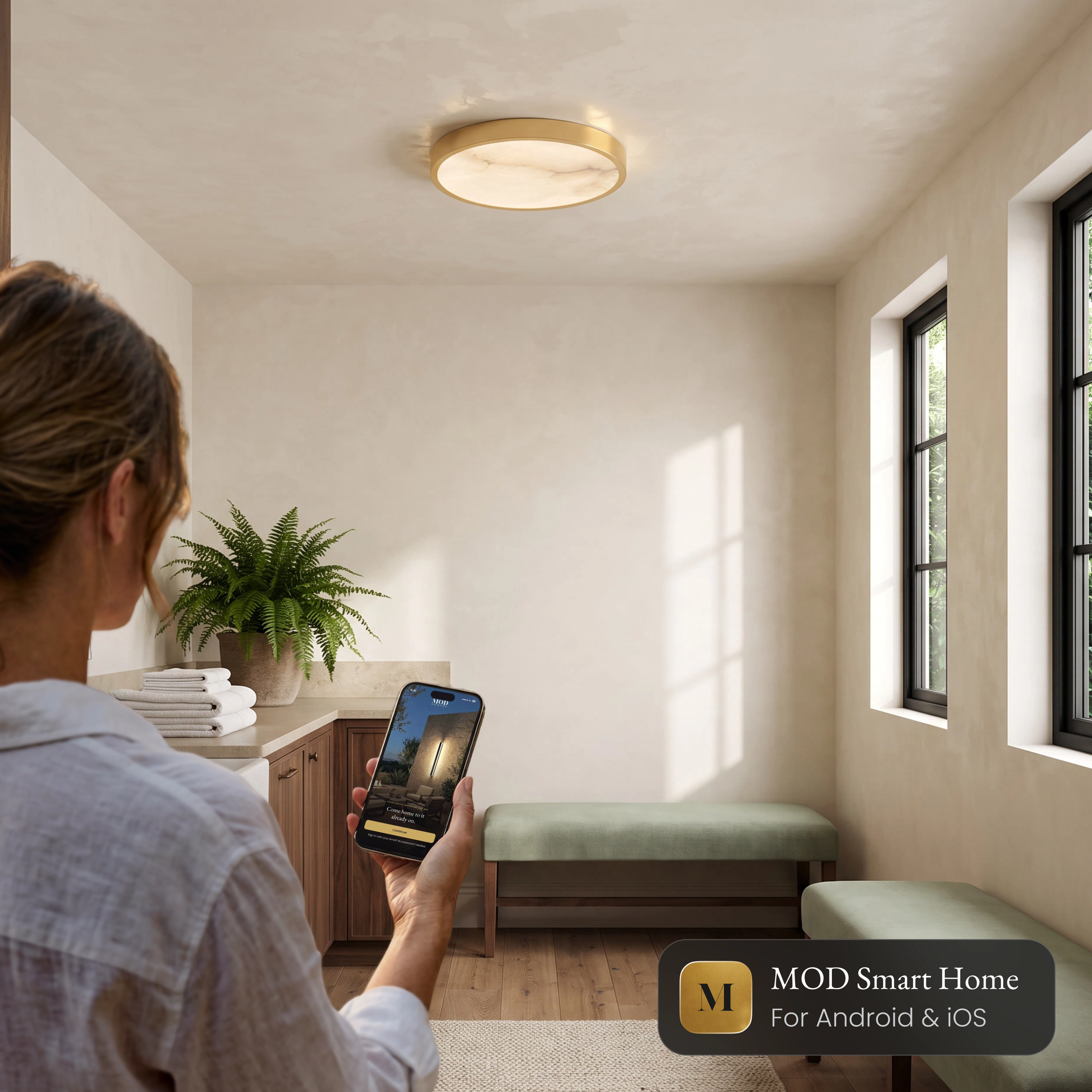 Celia Smart alabaster ceiling light in a hallway, controlled from the MOD Smart Home app on a phone
