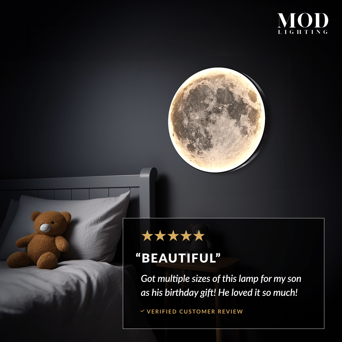 Luna moon lamp, lit full-moon disc on a black frame beside a child's bed with a teddy bear