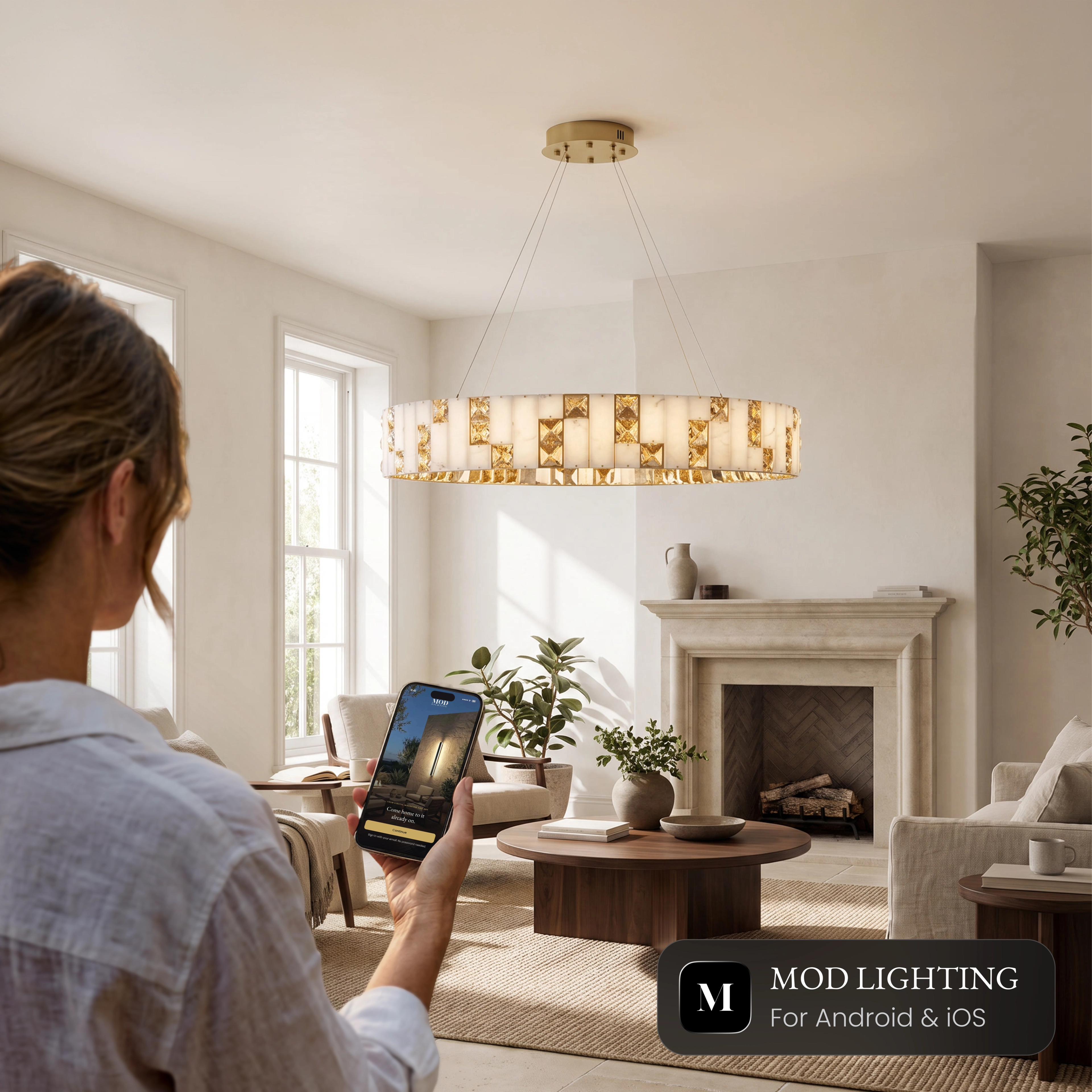 Seraphine Smart ring chandelier in a living room, controlled from the MOD LIGHTING app on a phone