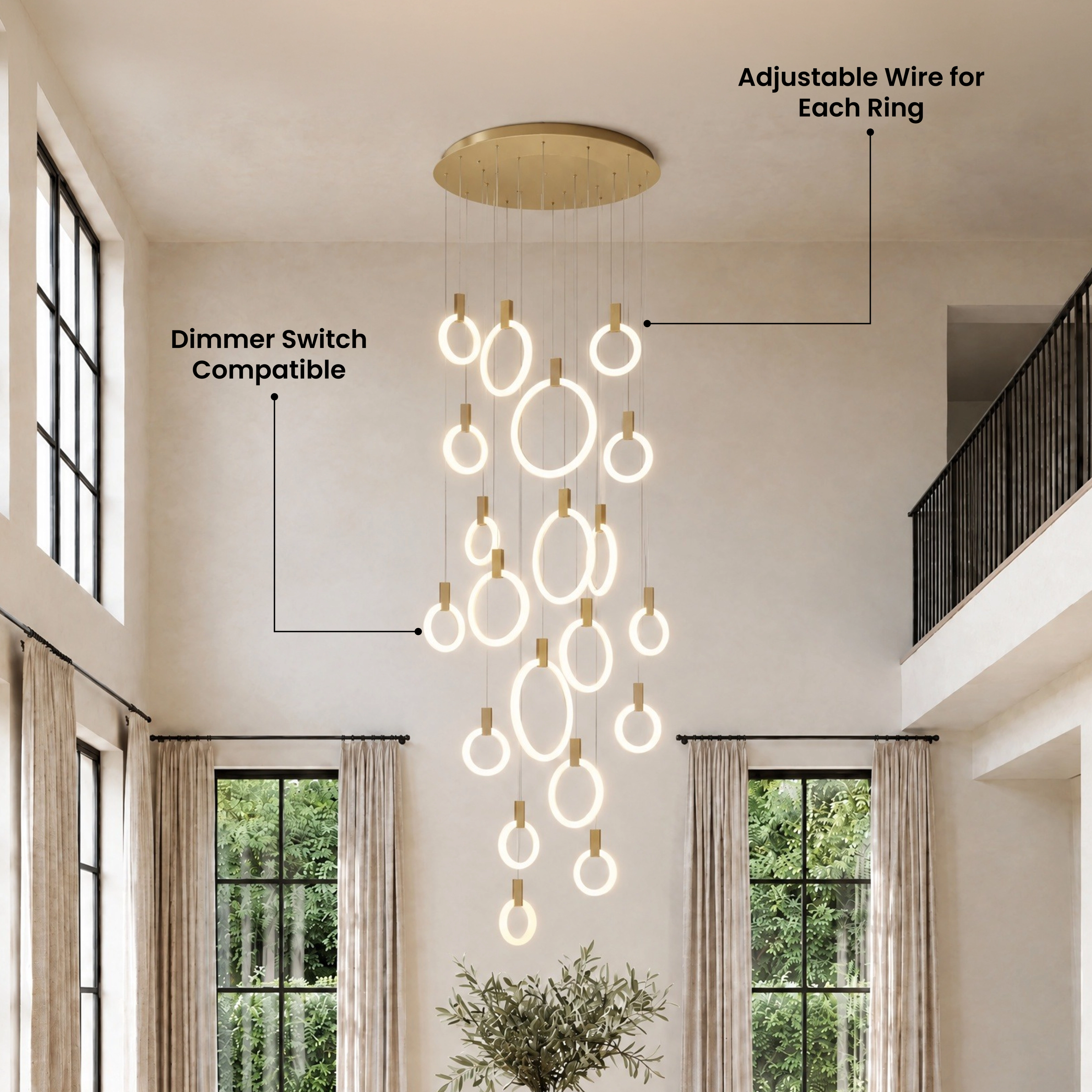 Skyla chandelier in gold, staggered lit rings cascading down a two-story staircase entryway