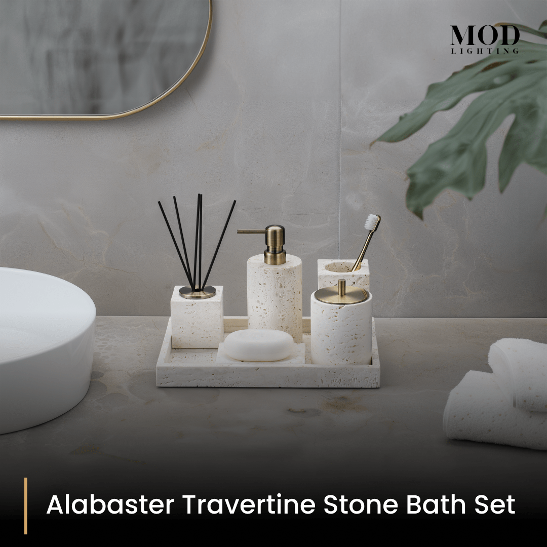 Alabaster Travertine bath set arranged on a tray on a pale vanity below a round mirror
