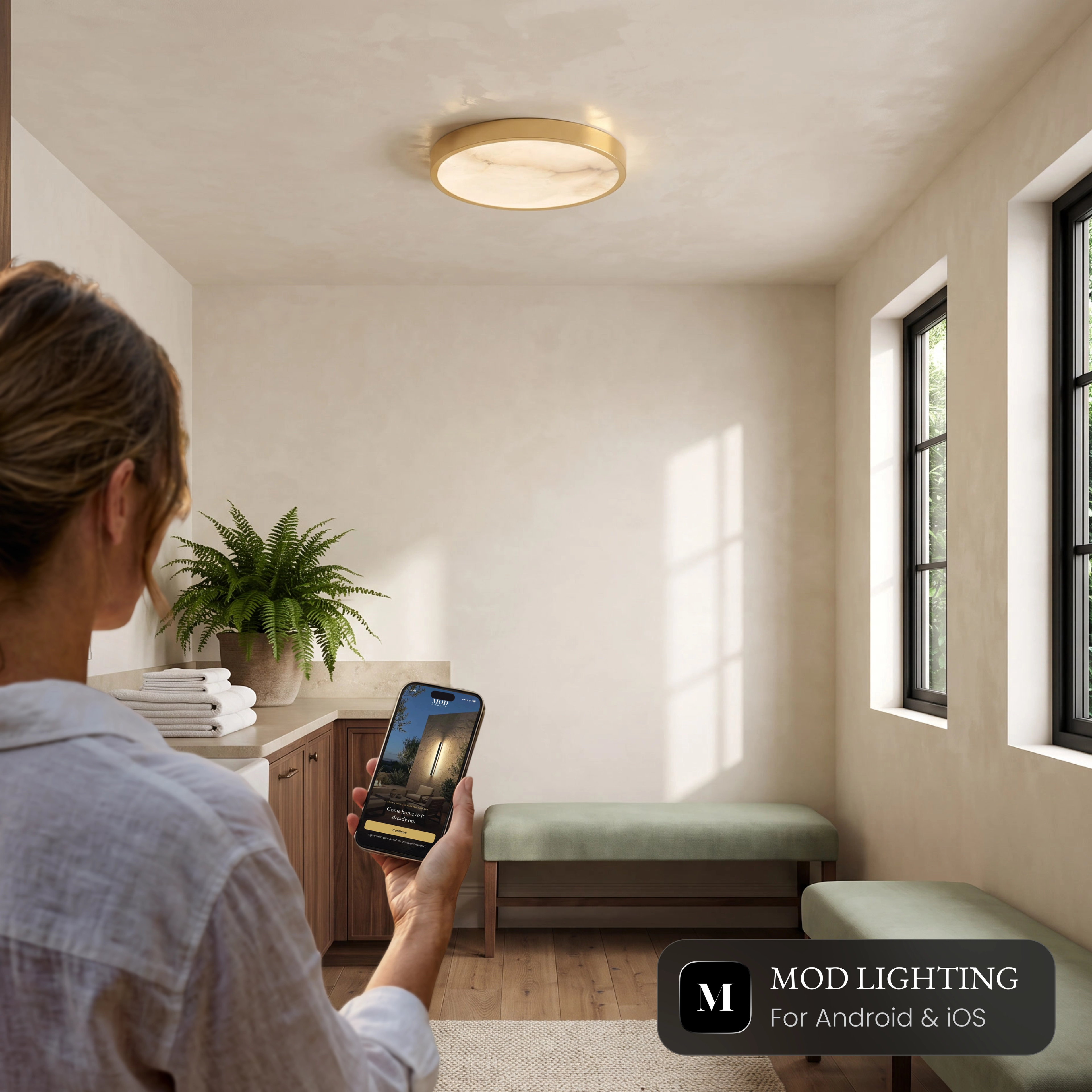 Celia Smart alabaster ceiling light in a hallway, controlled from the MOD LIGHTING app on a phone