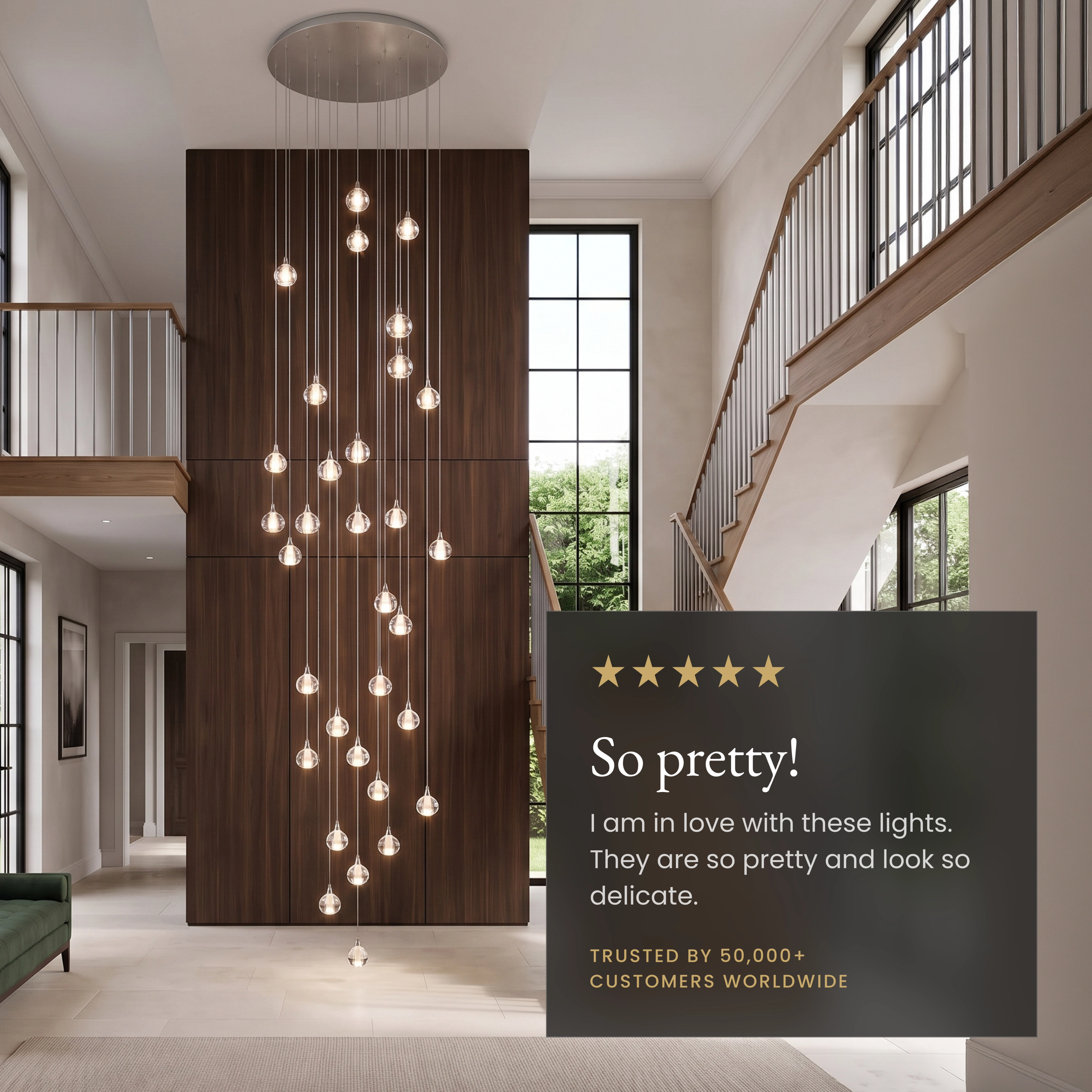 Sage clear-glass globe pendants cascading from a high ceiling over a gray living room