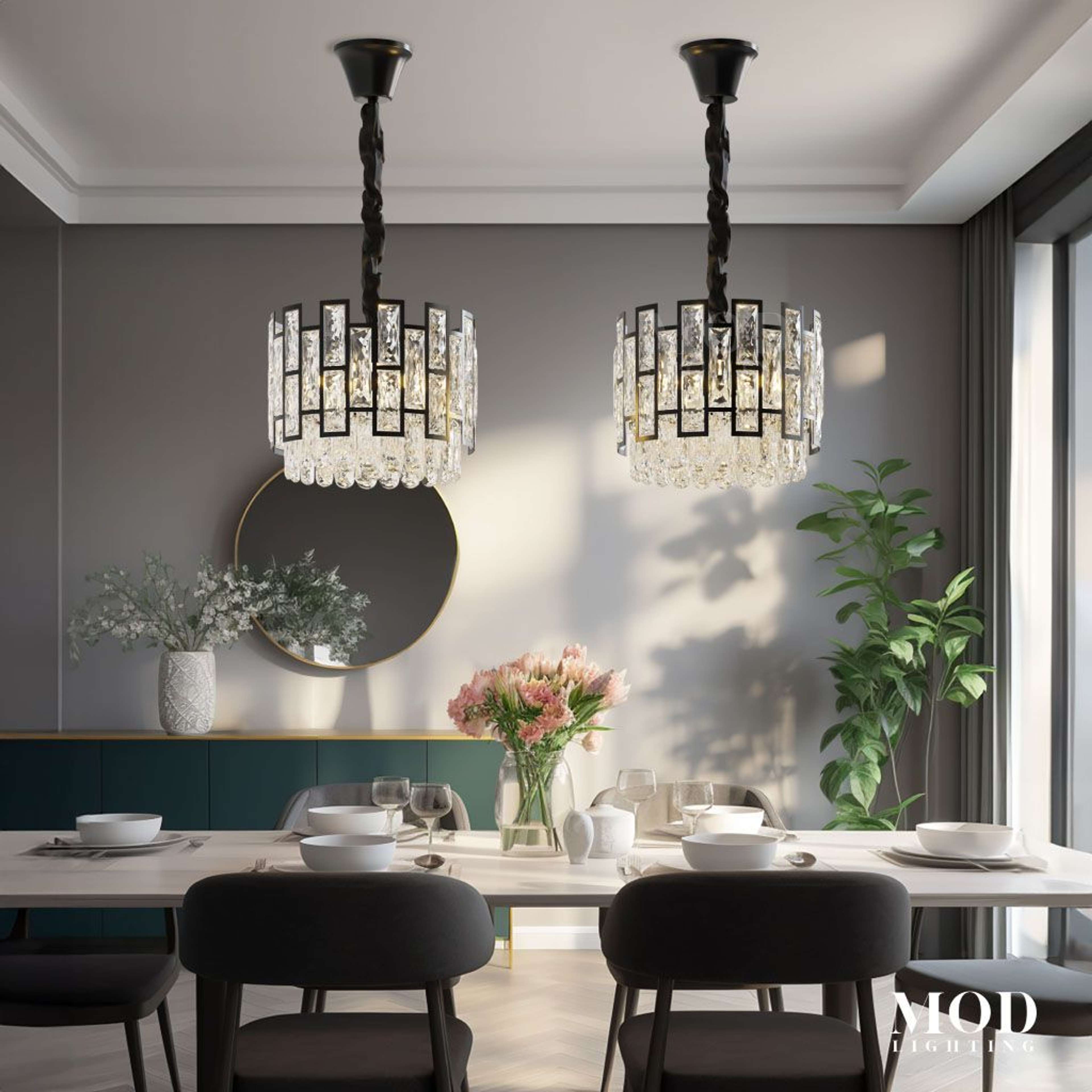 Mini Raven crystal pendants, black drum frames set with faceted crystal, above a dining table