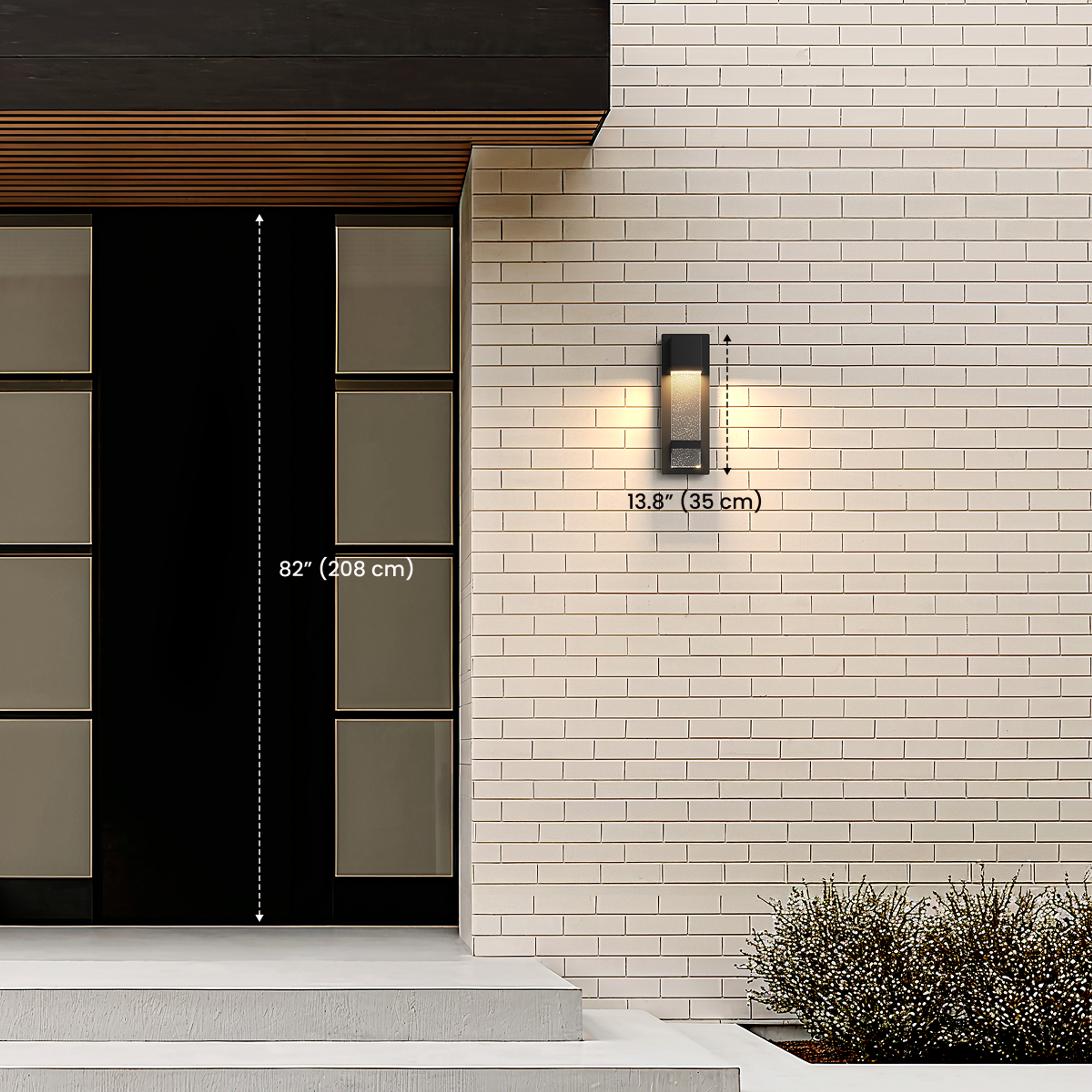 Nova black outdoor sconce by an entry door, dimension diagram noting 13.8 in / 35 cm height