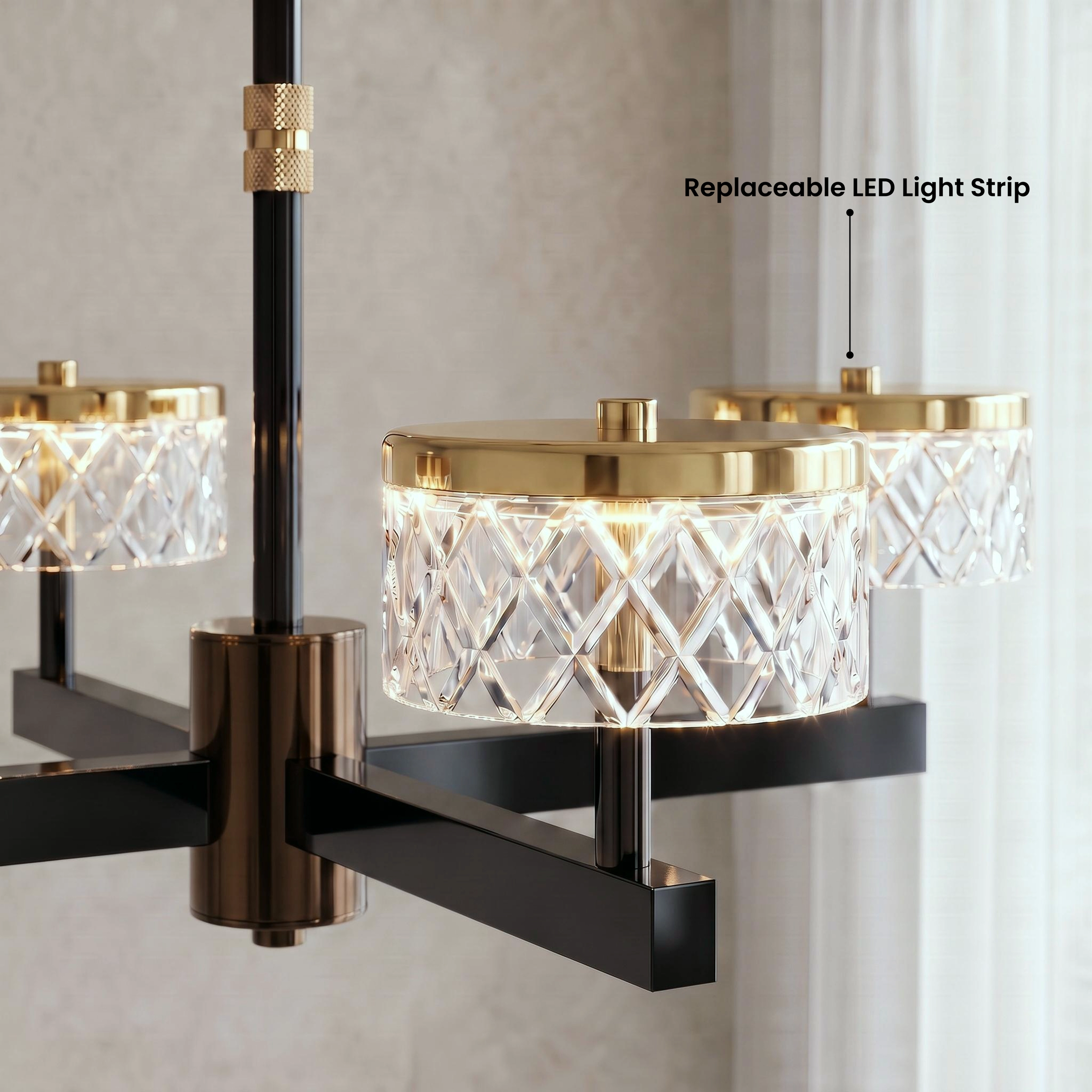 Emma warm-white chandelier in a stairwell hallway, available in two sizes and gold and pearl black