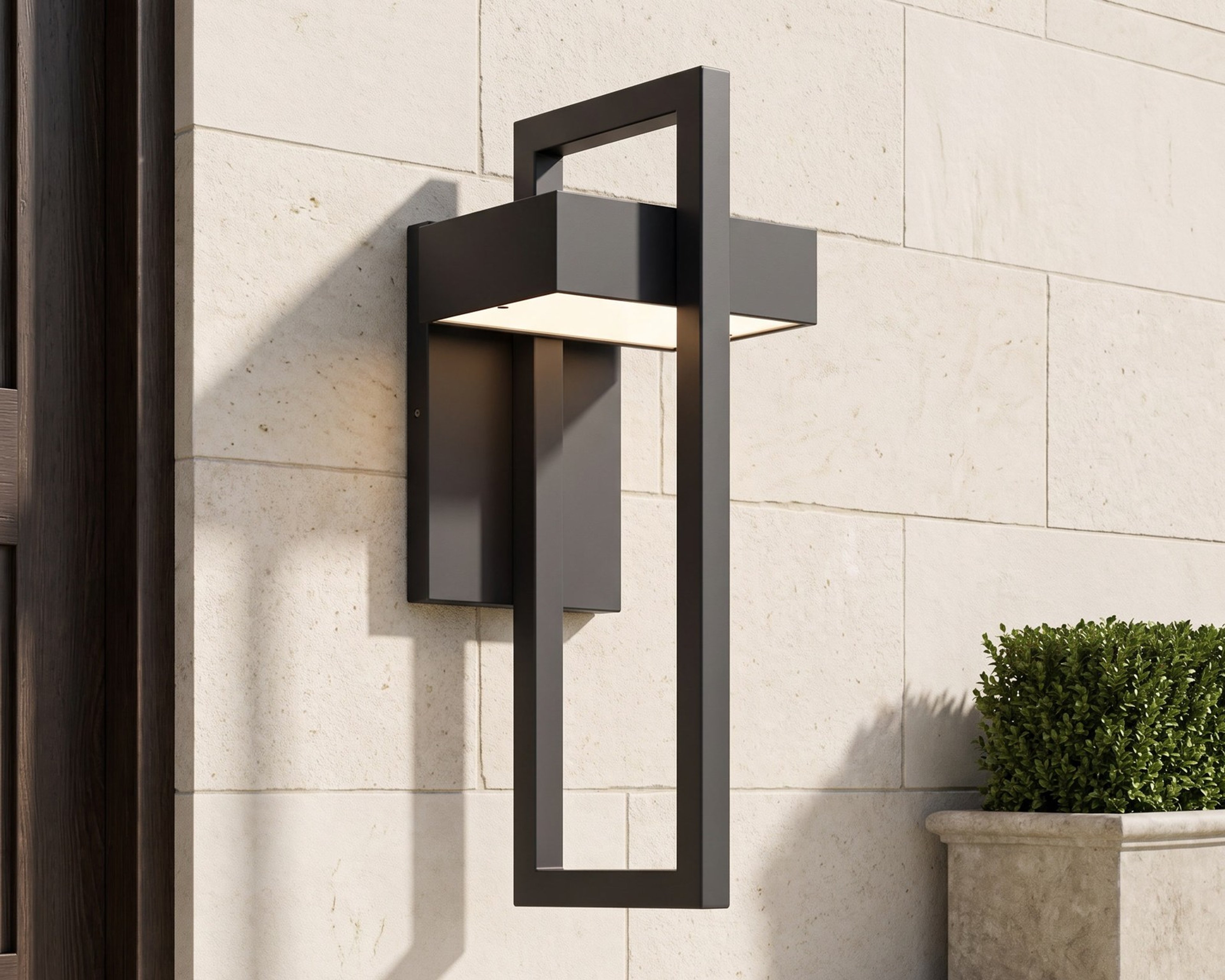 Terri, a black frame wall sconce, on a limestone facade