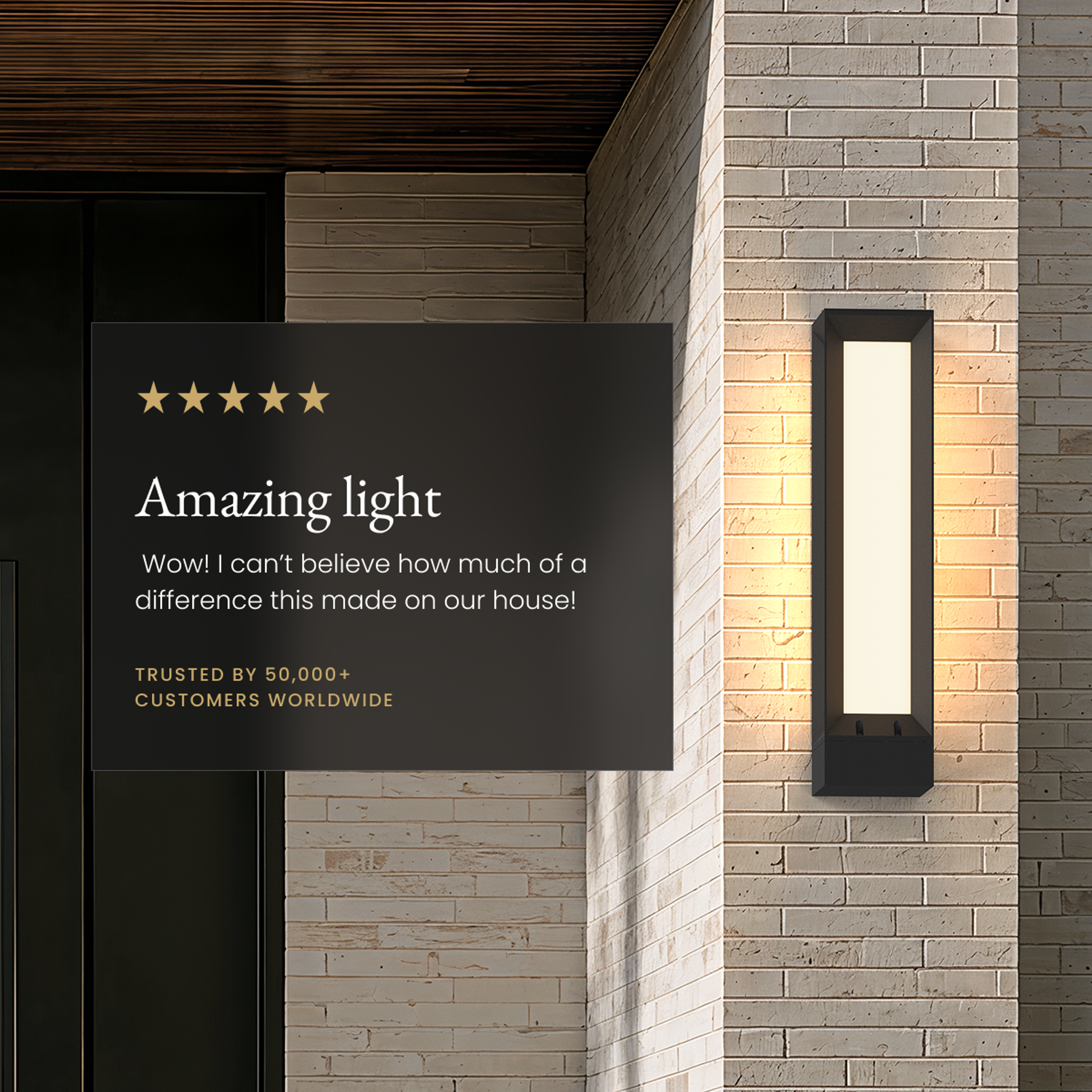 Haven black slim outdoor sconce glowing on a brick wall beside a five-star review card