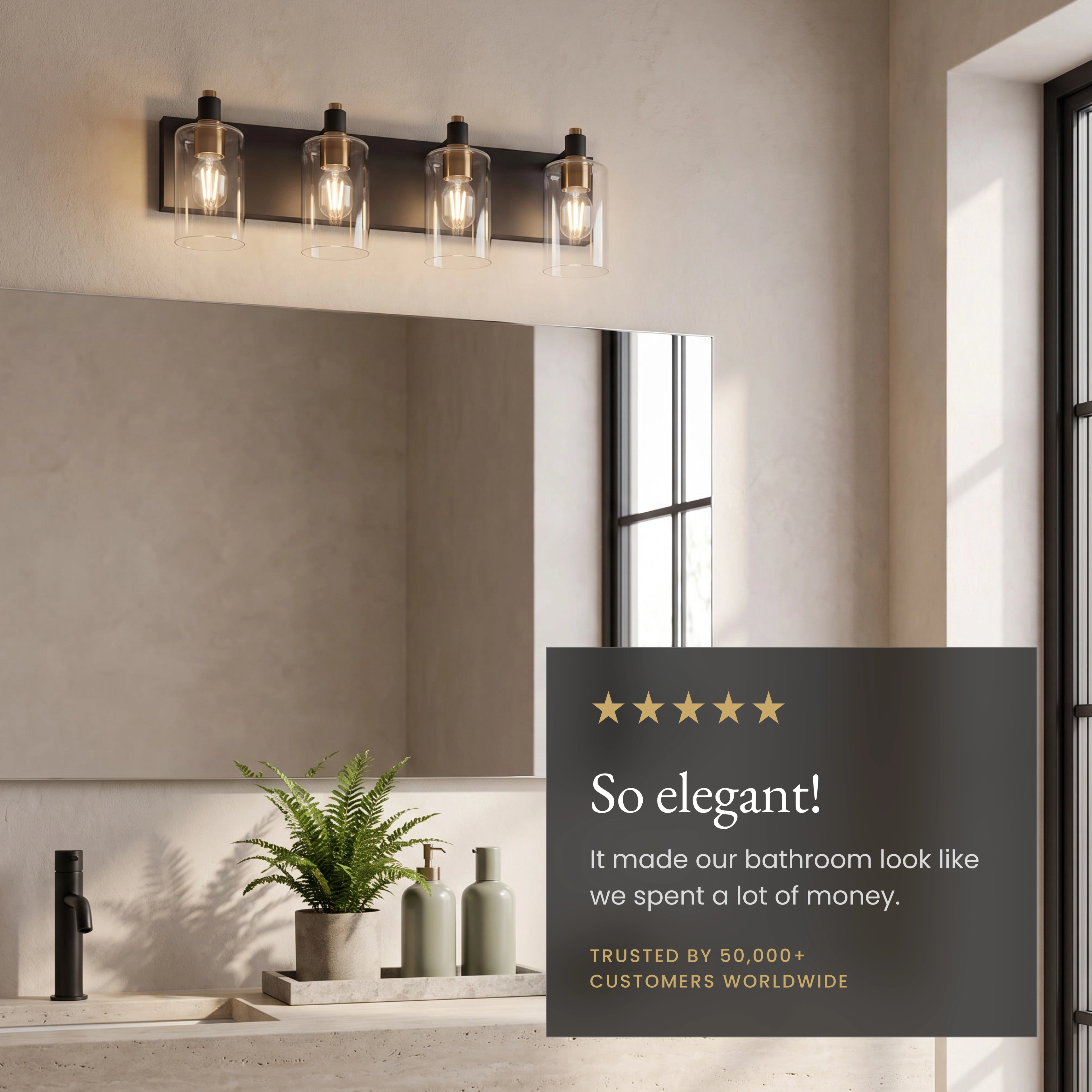 Hazel four-light black-and-gold vanity light over a mirror, with replaceable LED bulbs and dimmer-compatible