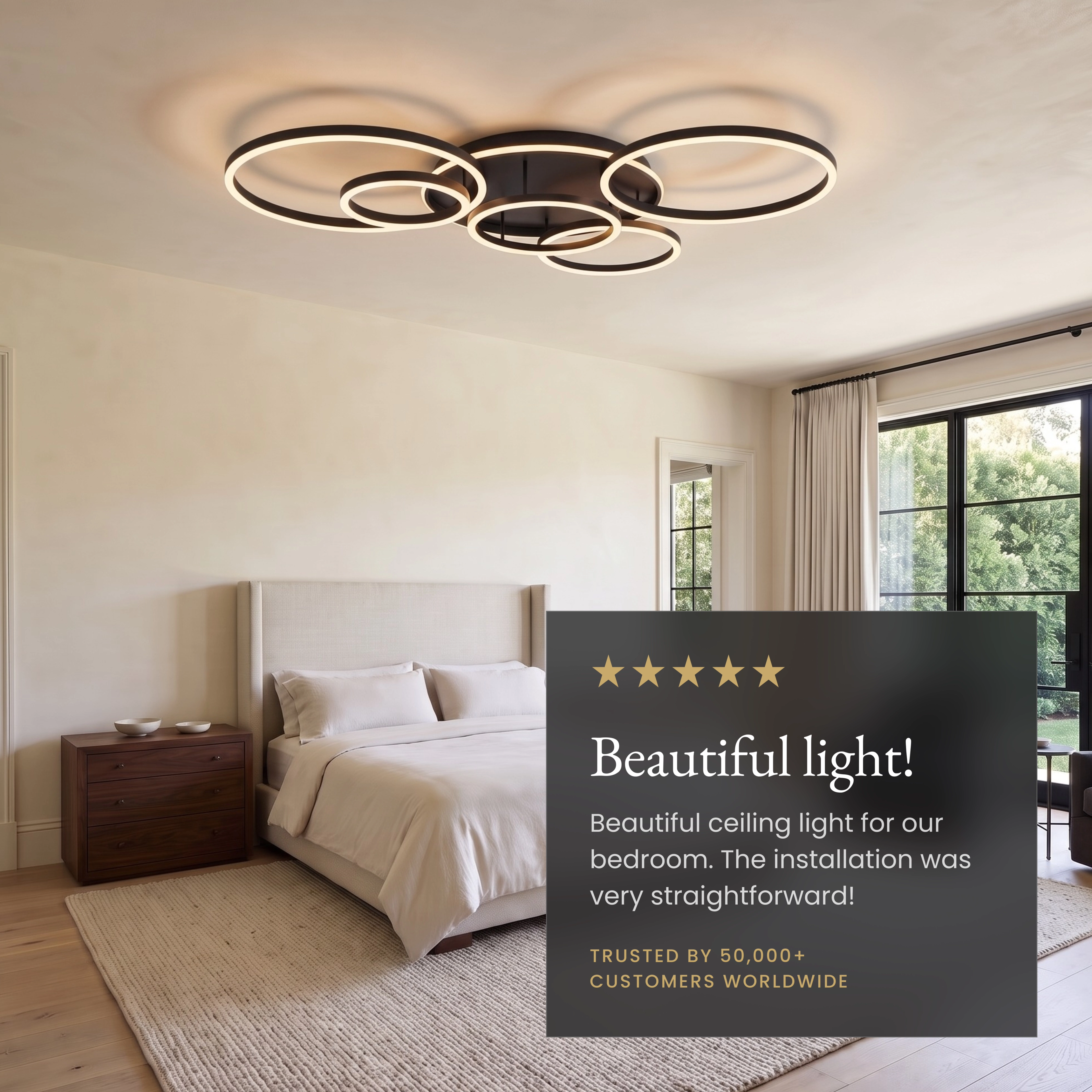 Chloe ceiling light, gold interlocking LED rings mounted above a bed