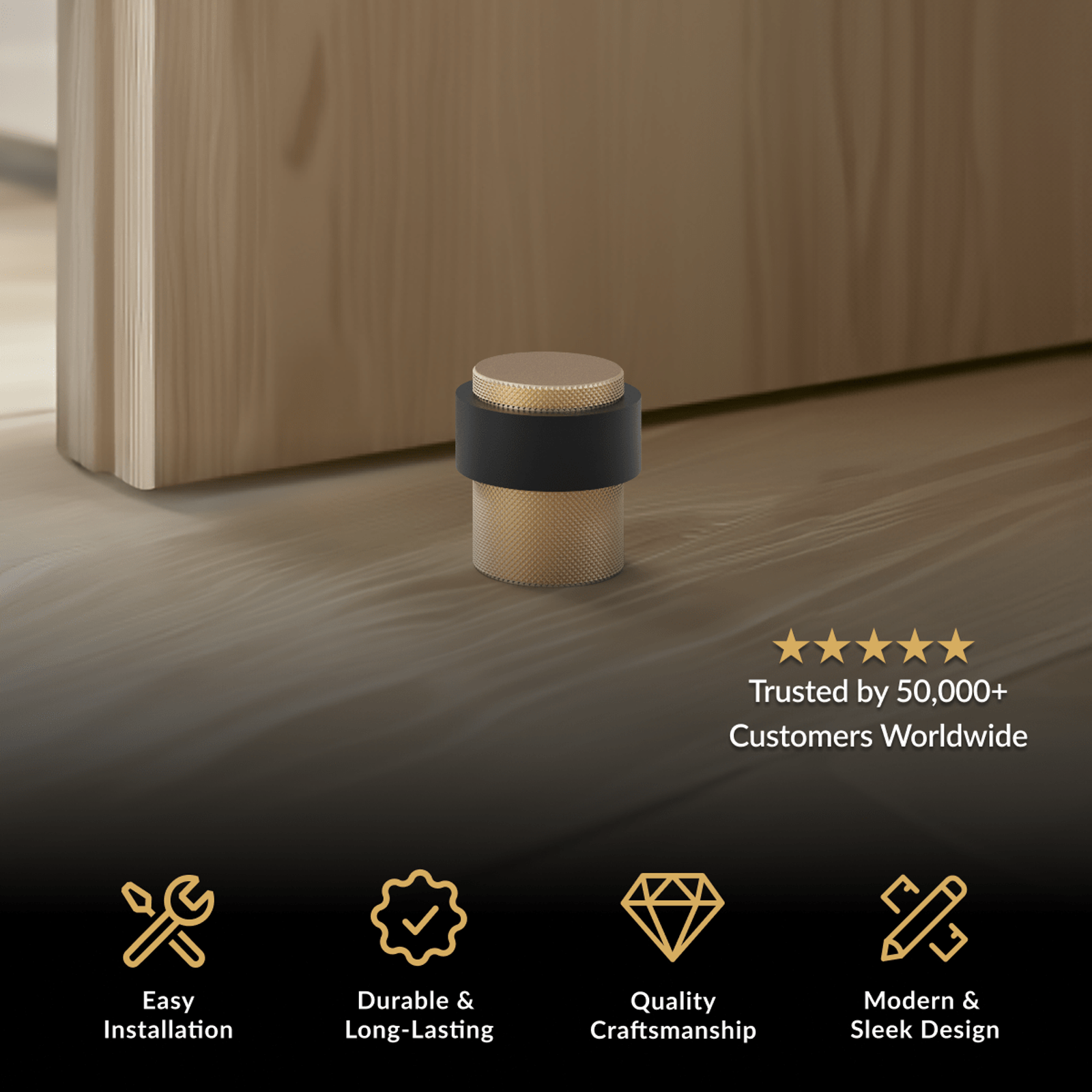 Enso Door Stop, brushed gold floor stop with wide black rubber band beside a wood door