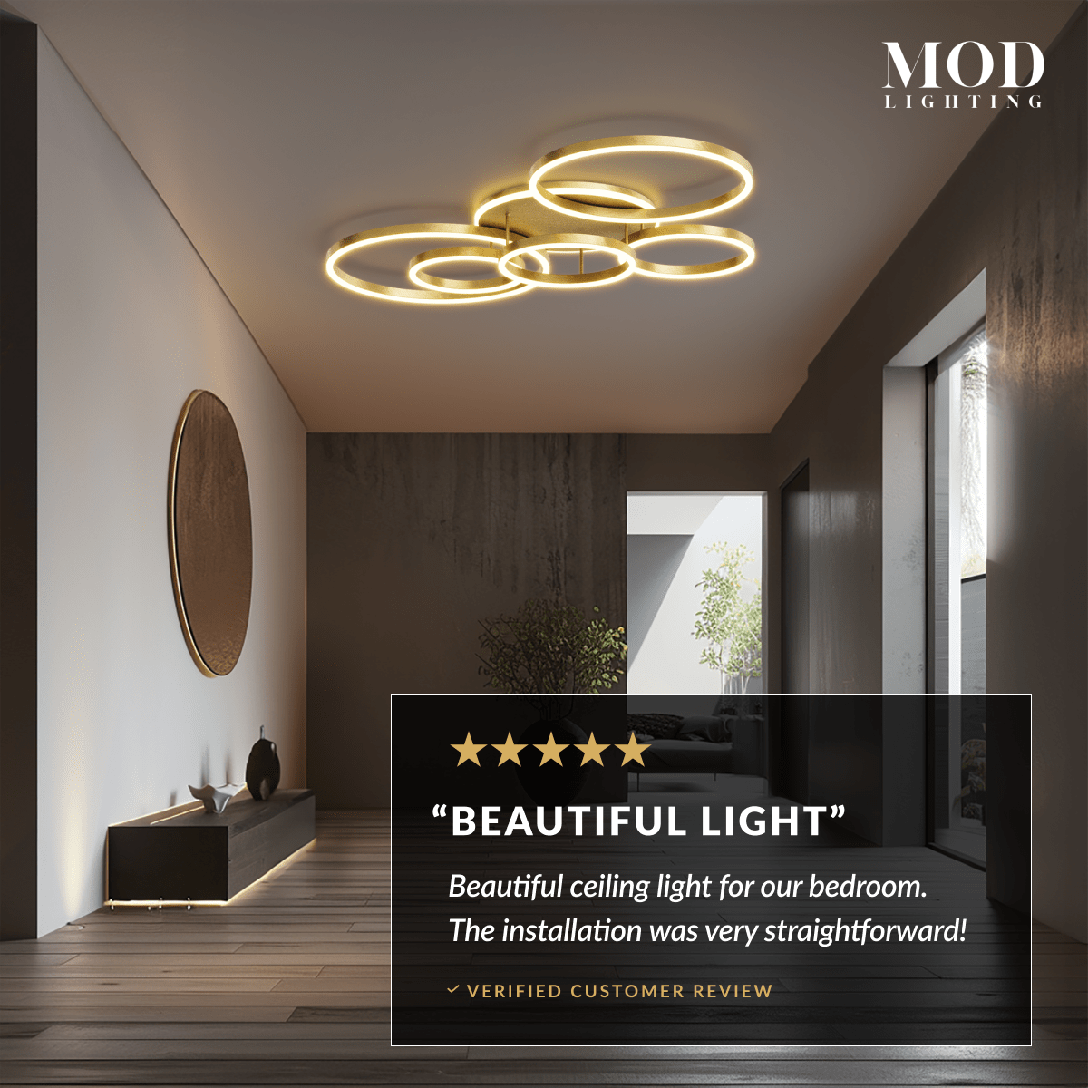 Chloe ceiling light, gold interlocking LED rings on ceiling of a hallway