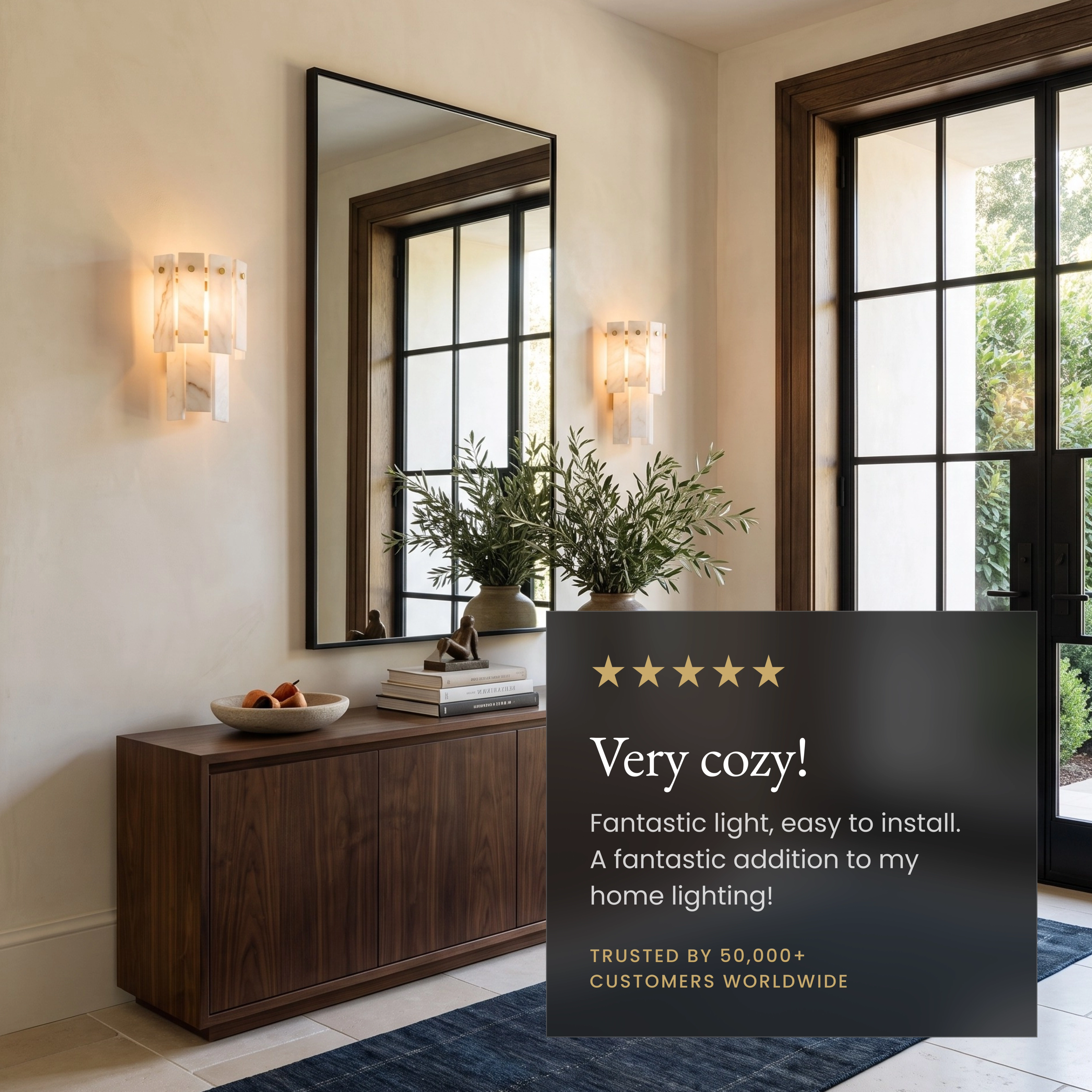 Velina Sconce gold wall light with layered white alabaster panels glowing on a neutral stone wall