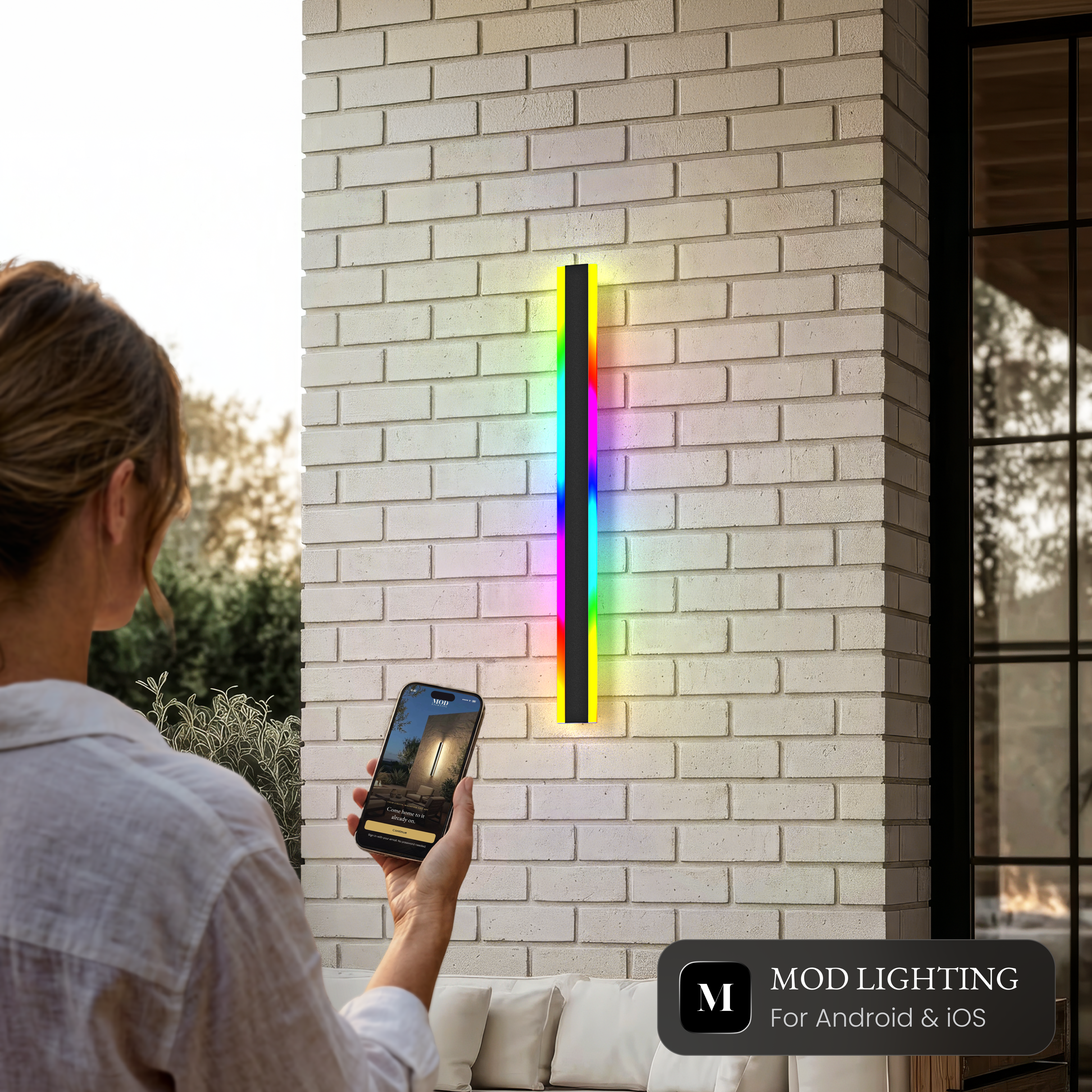 Haylen RGB smart LED bar wall light on brick, controlled from the MOD Smart Home app for Android and iOS