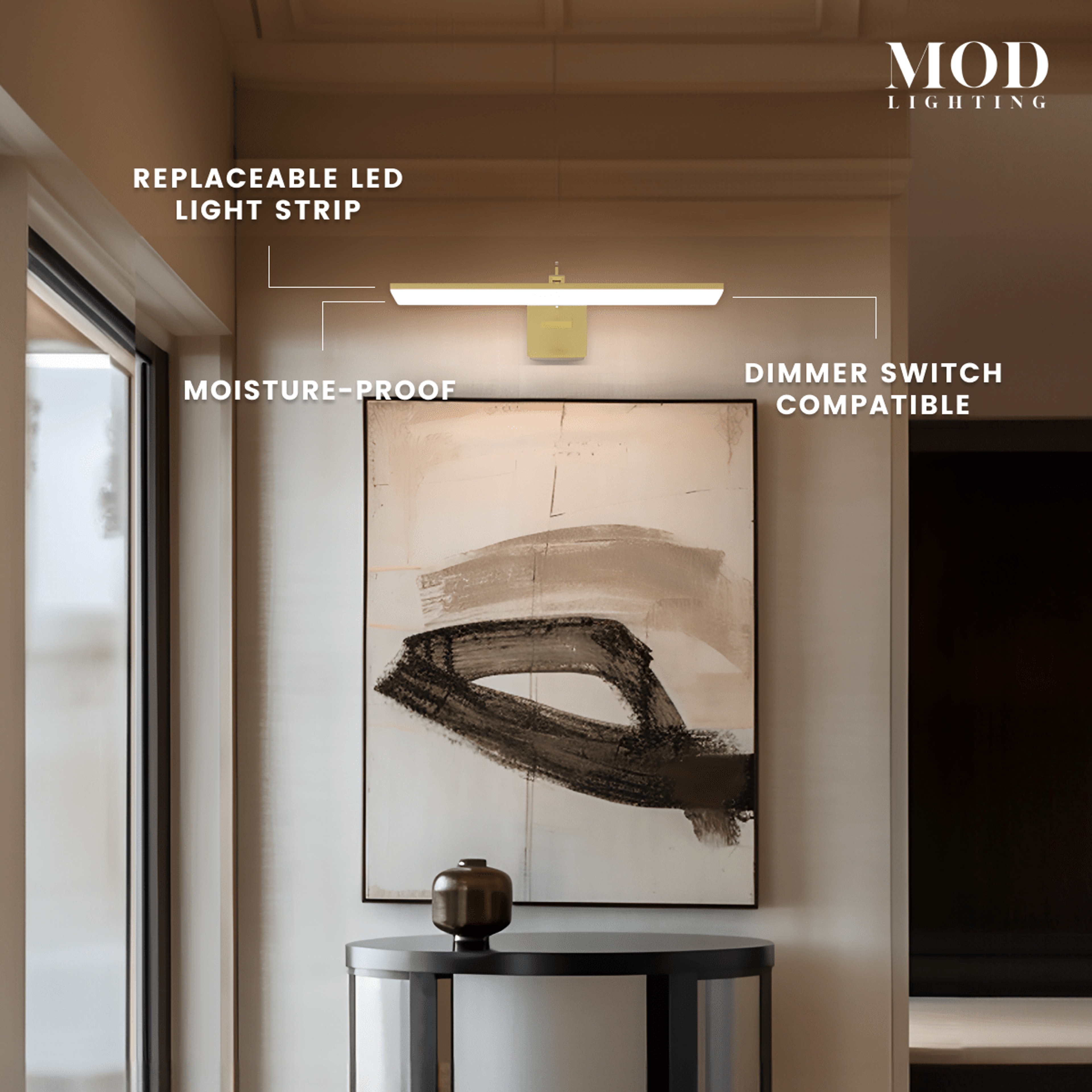 Zena slim horizontal LED bar vanity light glowing warm, mounted above framed art in a hallway