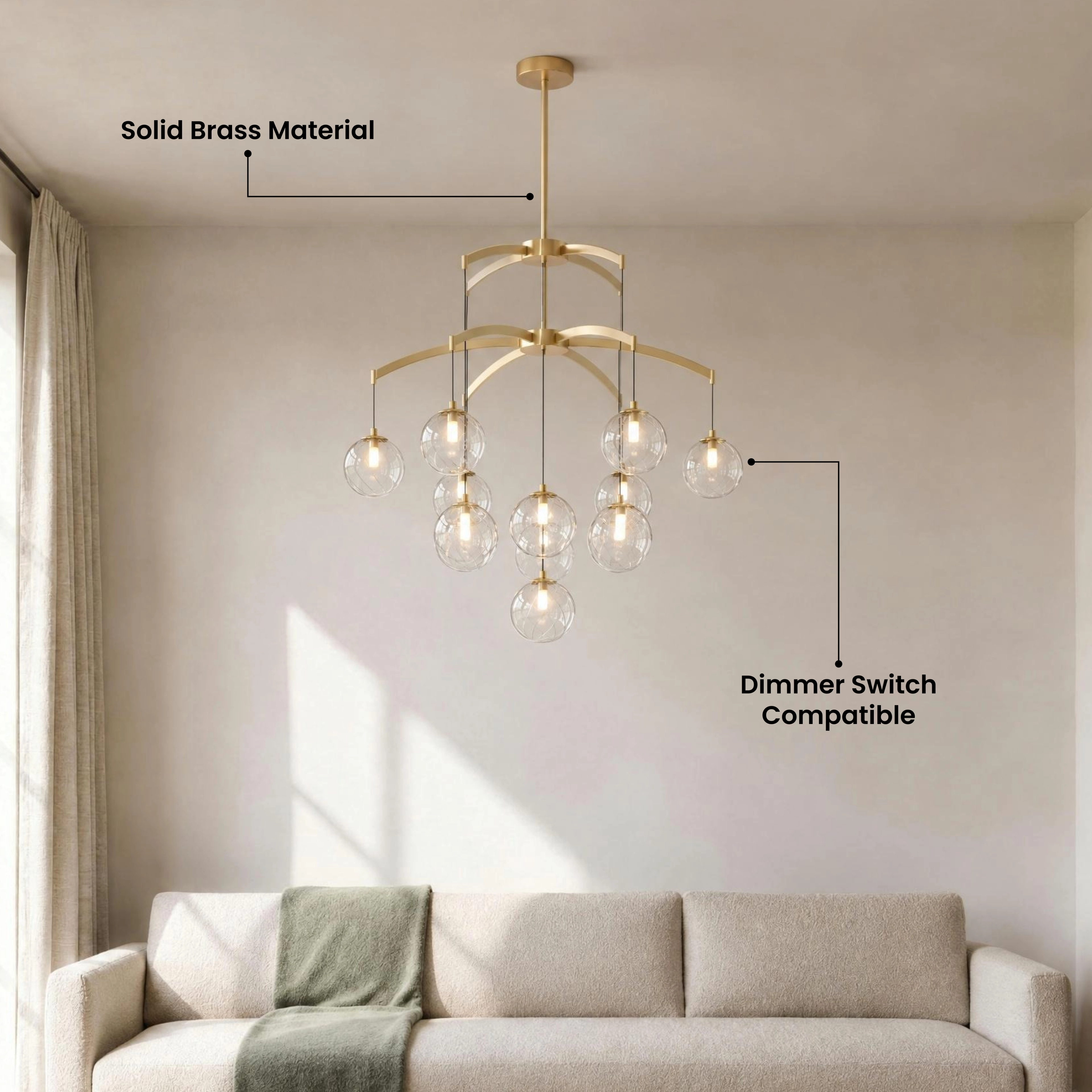 Mirella brushed-gold chandelier with tiered amber glass globes glowing over a neutral living room with a fireplace