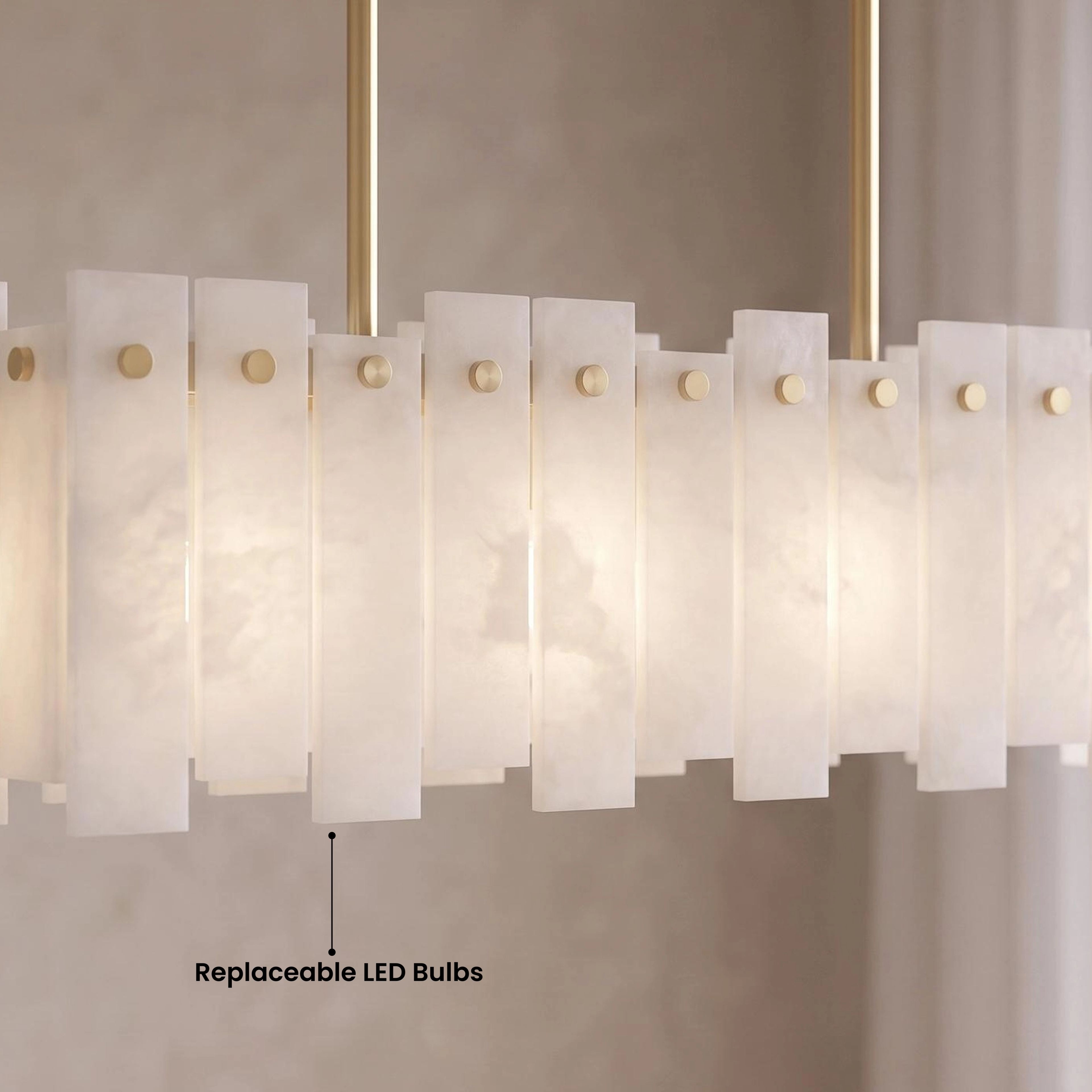 Velina Pendant gold linear alabaster fixture with panelled shade over a marble kitchen island