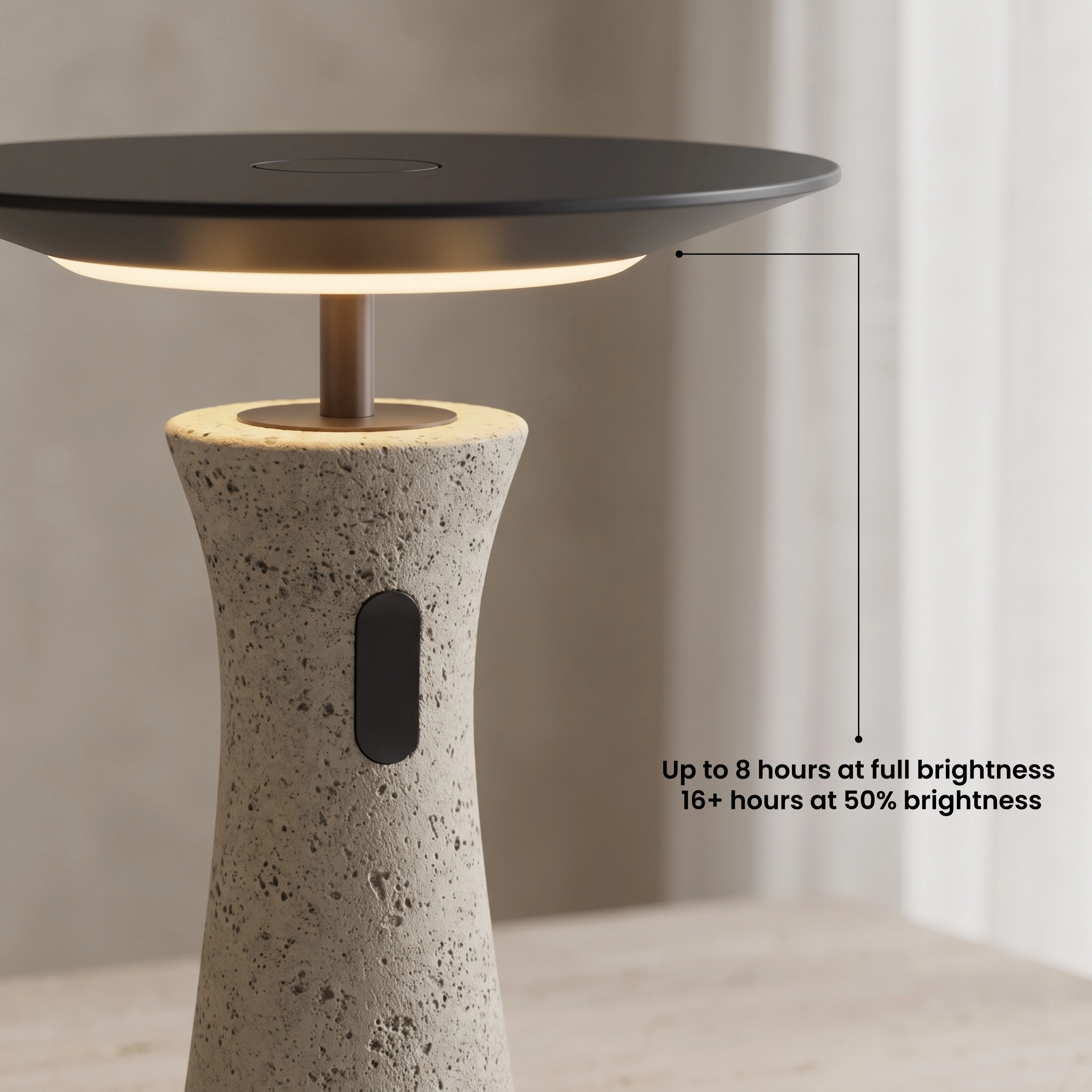 Dara tapered travertine table lamp glowing warm white on a wood console in a living room