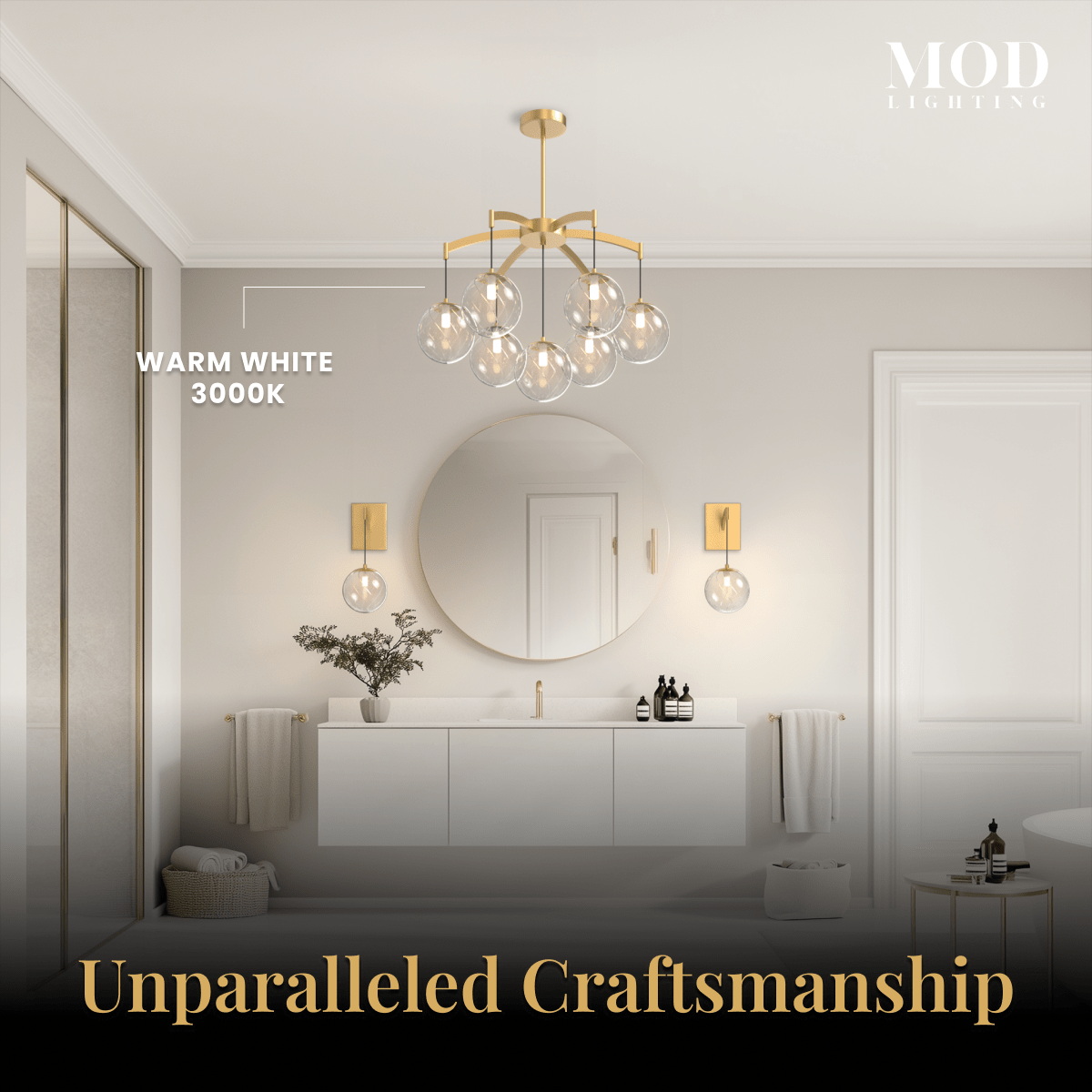 Mirella brushed-gold globe chandelier and matching sconces lighting a warm neutral bathroom with round mirror