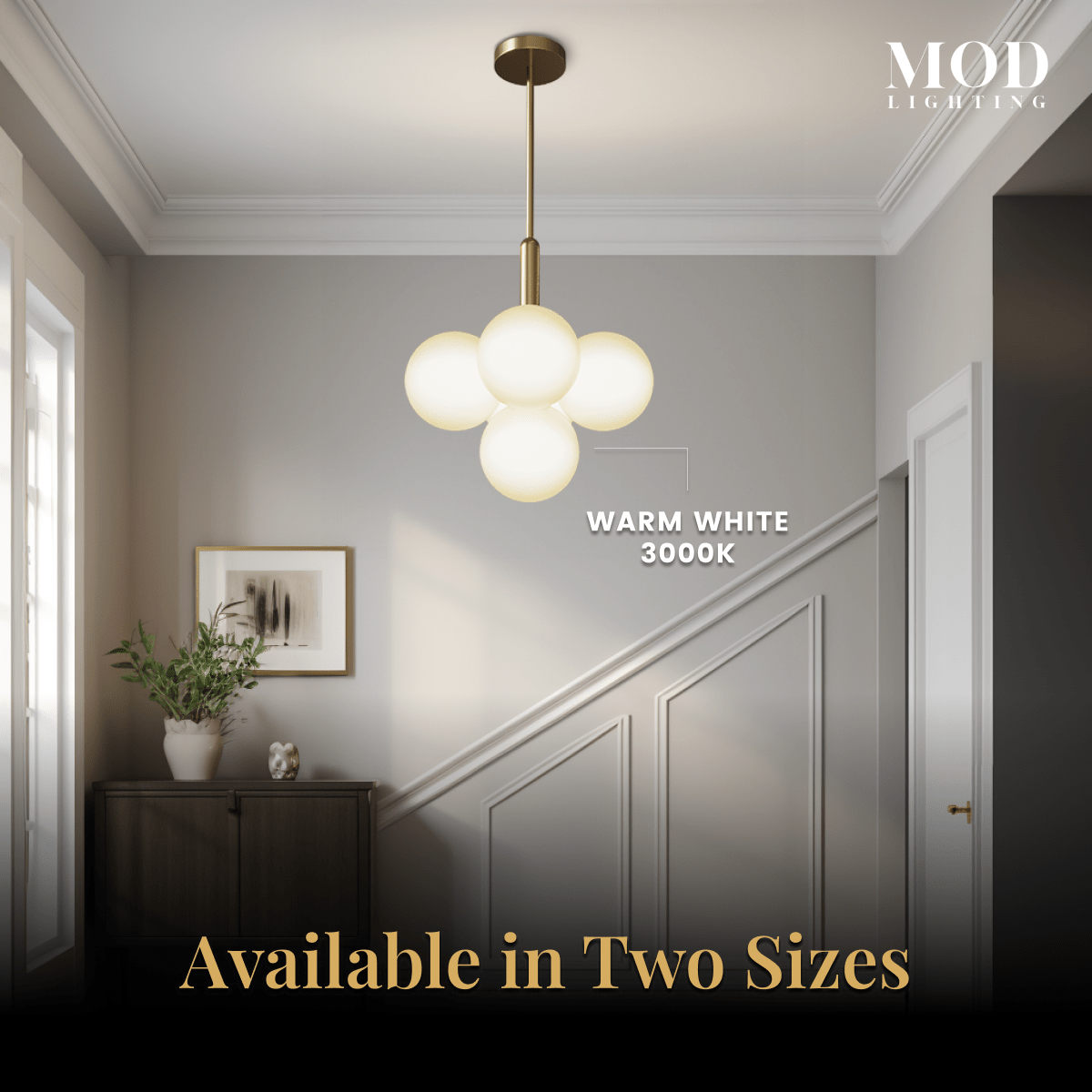 Angelica gold pendant, four white opal-glass globes on a brass rod, in a paneled stairway hall