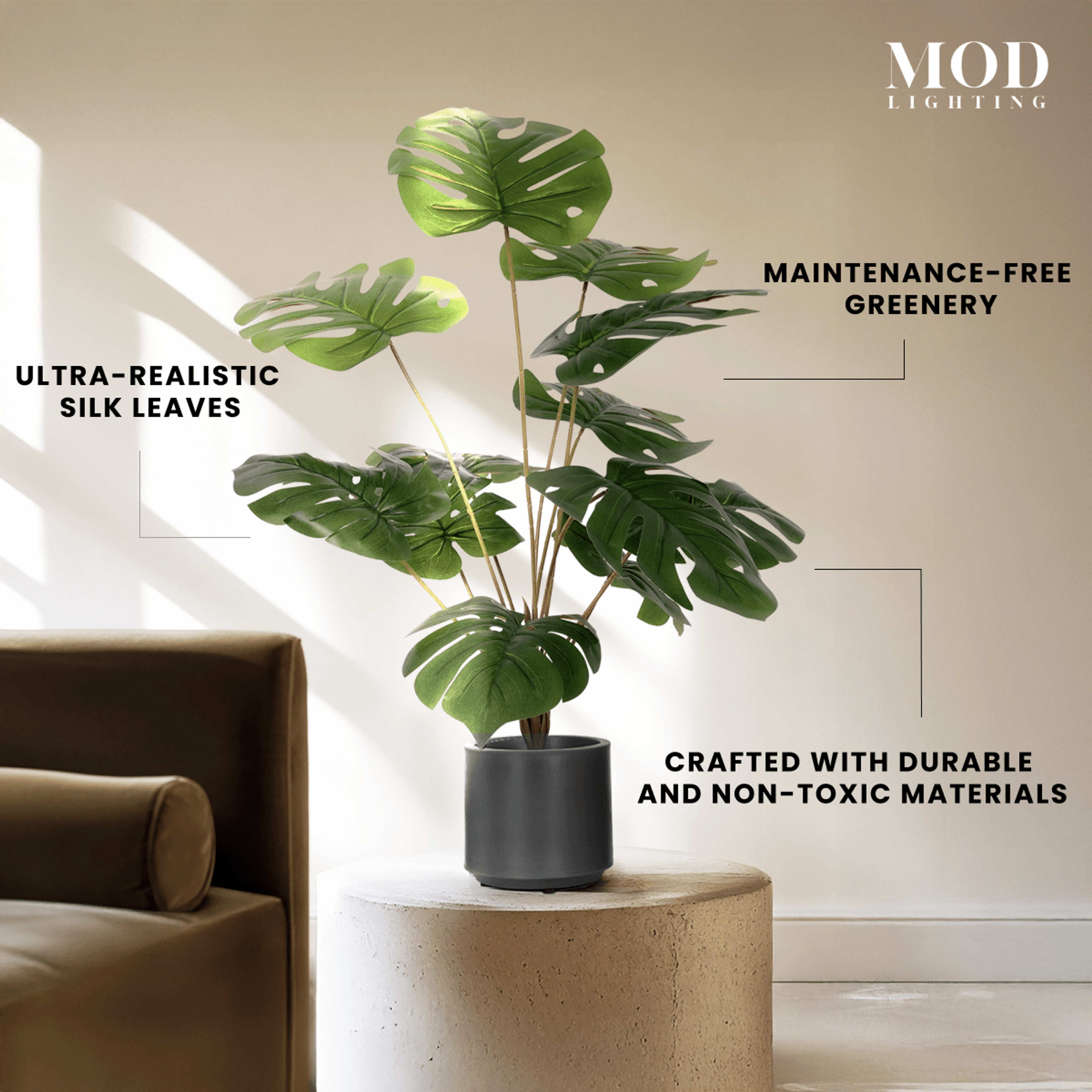 Monstera in a black pot on a stone side table, labeled maintenance-free with ultra-realistic silk leaves