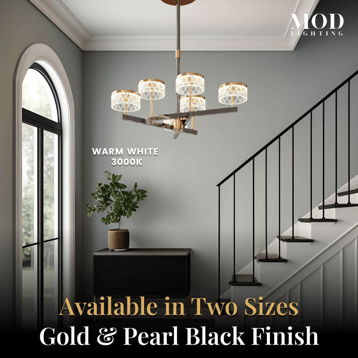 Emma warm-white chandelier in a stairwell hallway, available in two sizes and gold and pearl black