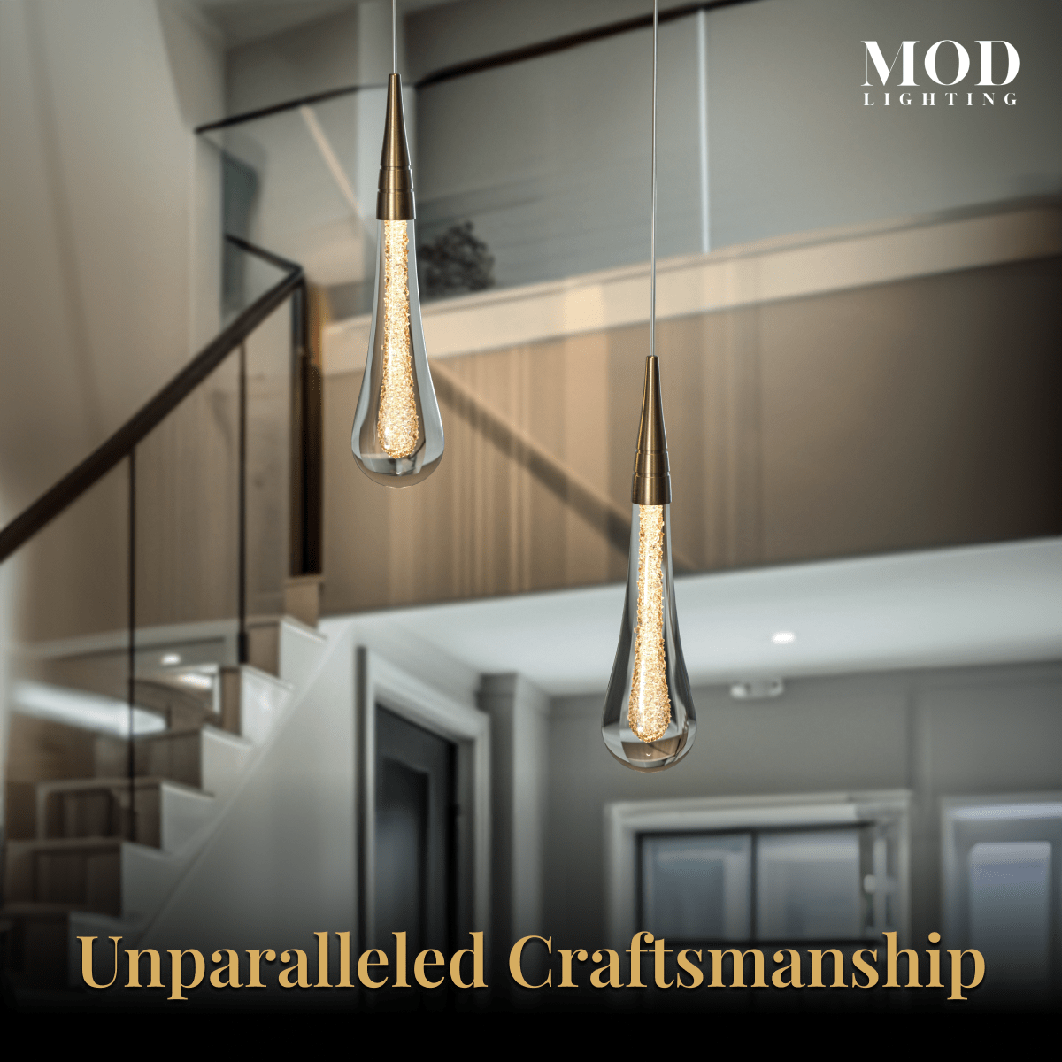 Indra chandelier detail, two lit crystal teardrops on gold stems in an entryway