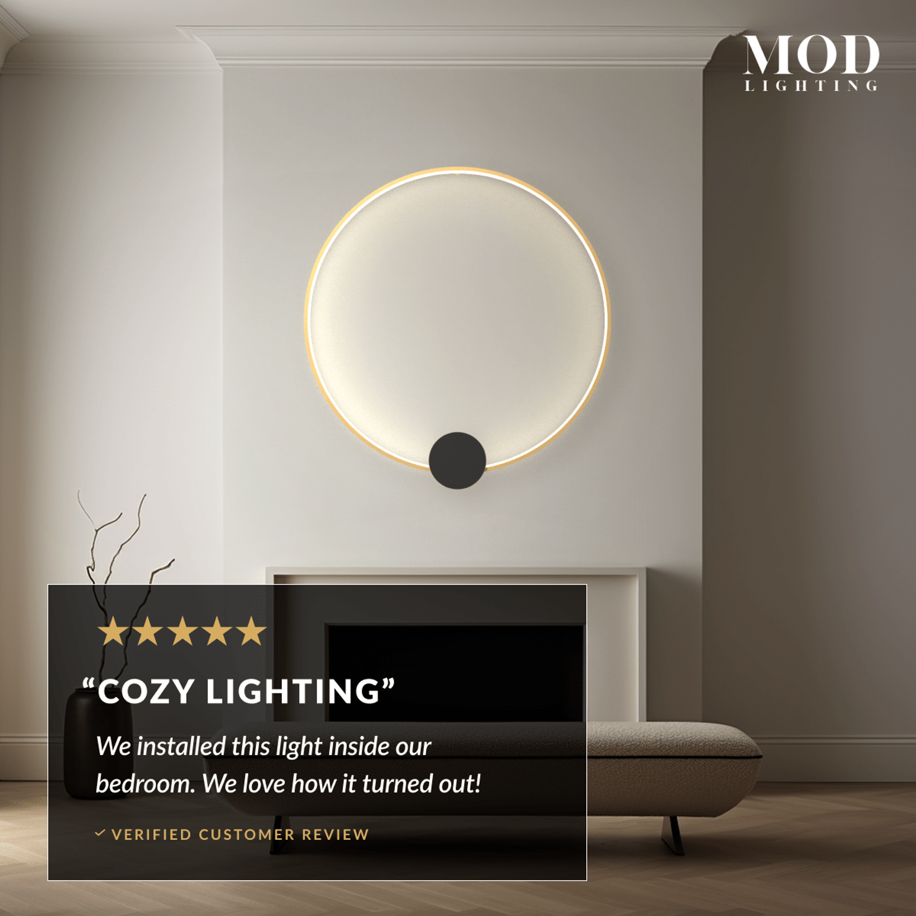 Halo gold ring wall lamp with black disc center, glowing above a fireplace in a neutral living room