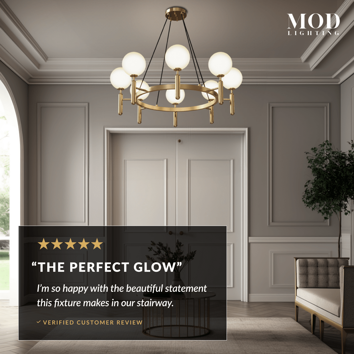 Angelica gold ring chandelier, six white opal-glass globes on a brass hoop, in a paneled stairwell