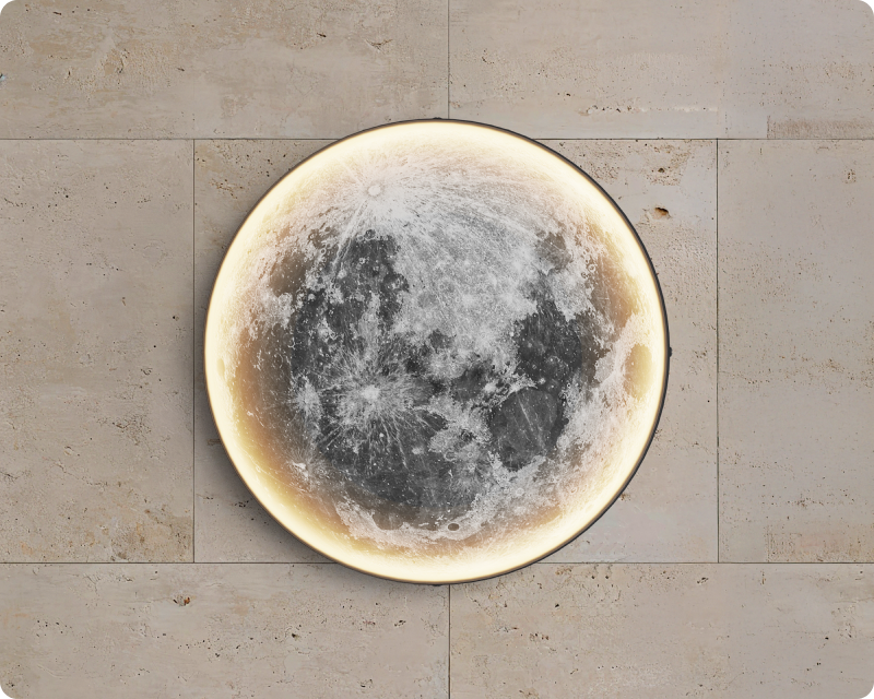 Luna, a circular moon wall light, on a stone facade