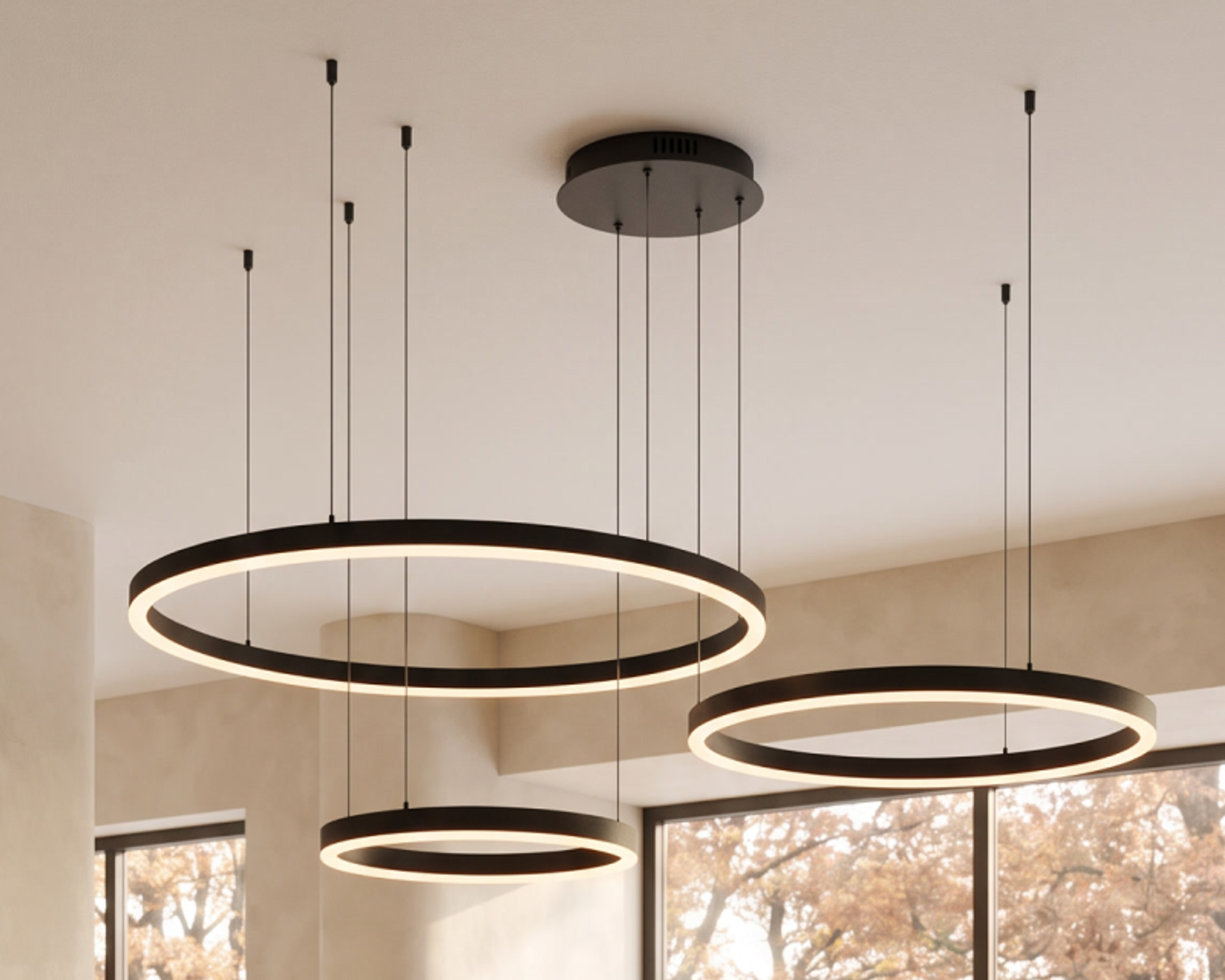 Ring, a brushed brass ring chandelier, against a panelled wall