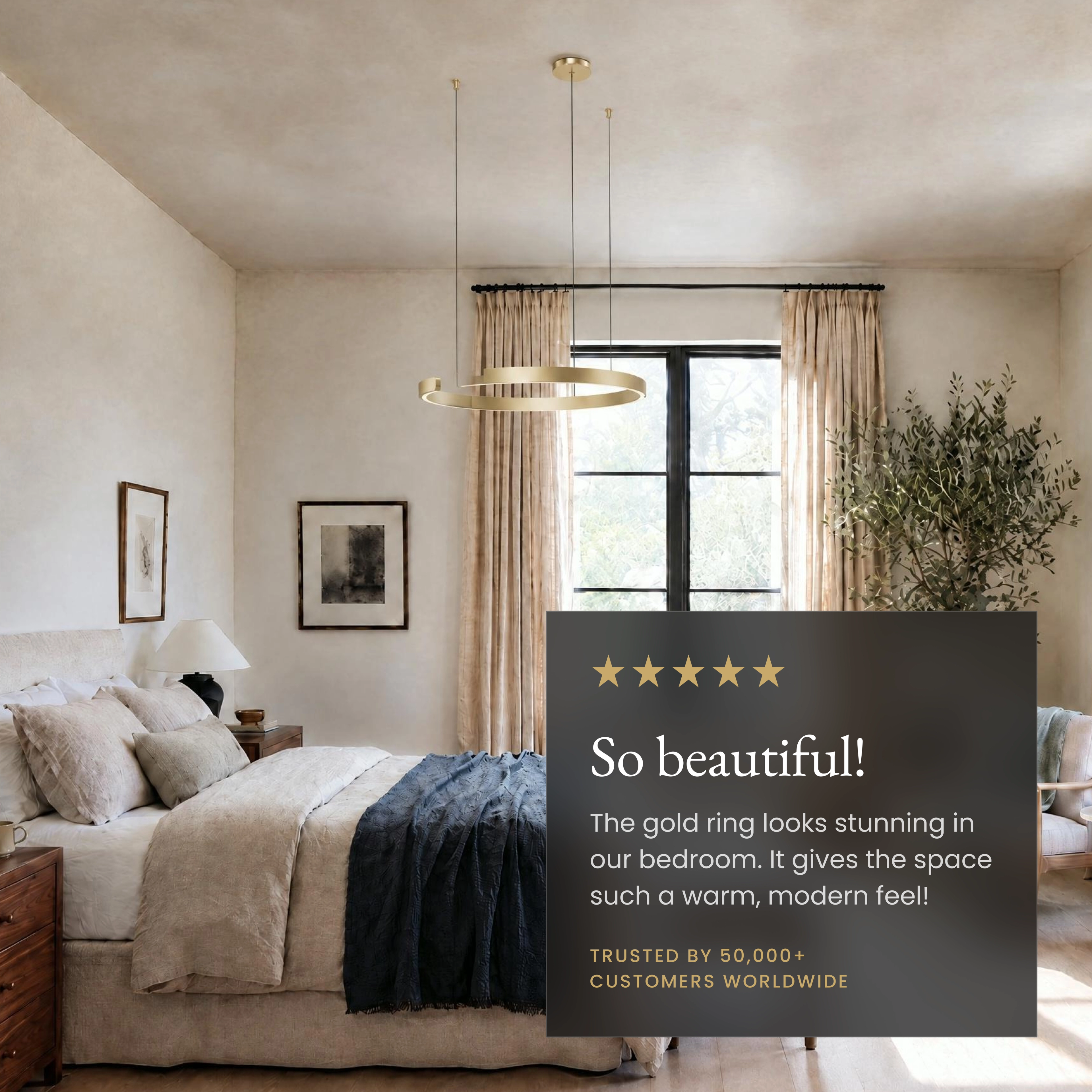 Ring chandelier in gold, open circular band pendant lit over a sofa and marble coffee table in a living room