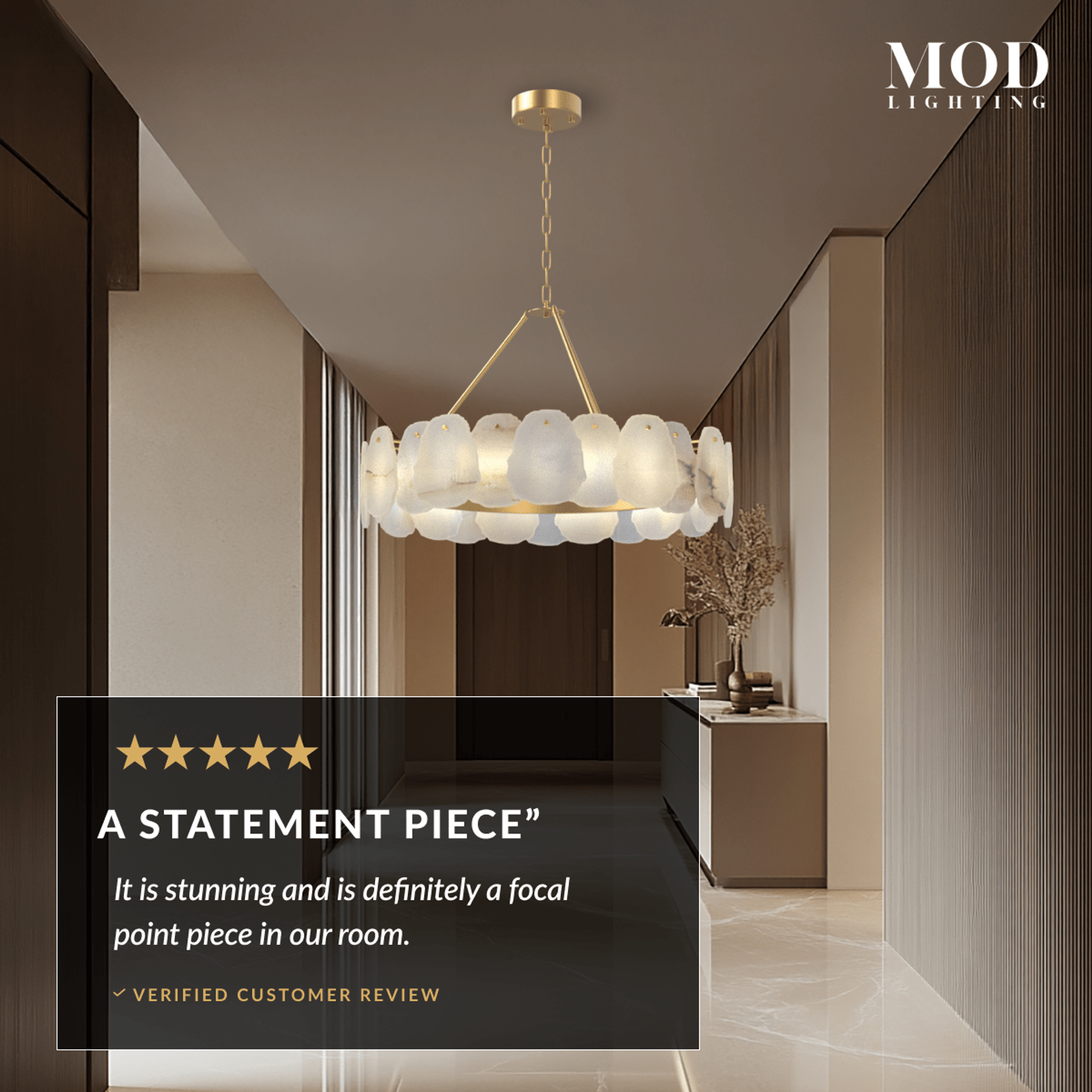 Alba gold and alabaster petal drum chandelier glowing in a hallway with wood and marble walls
