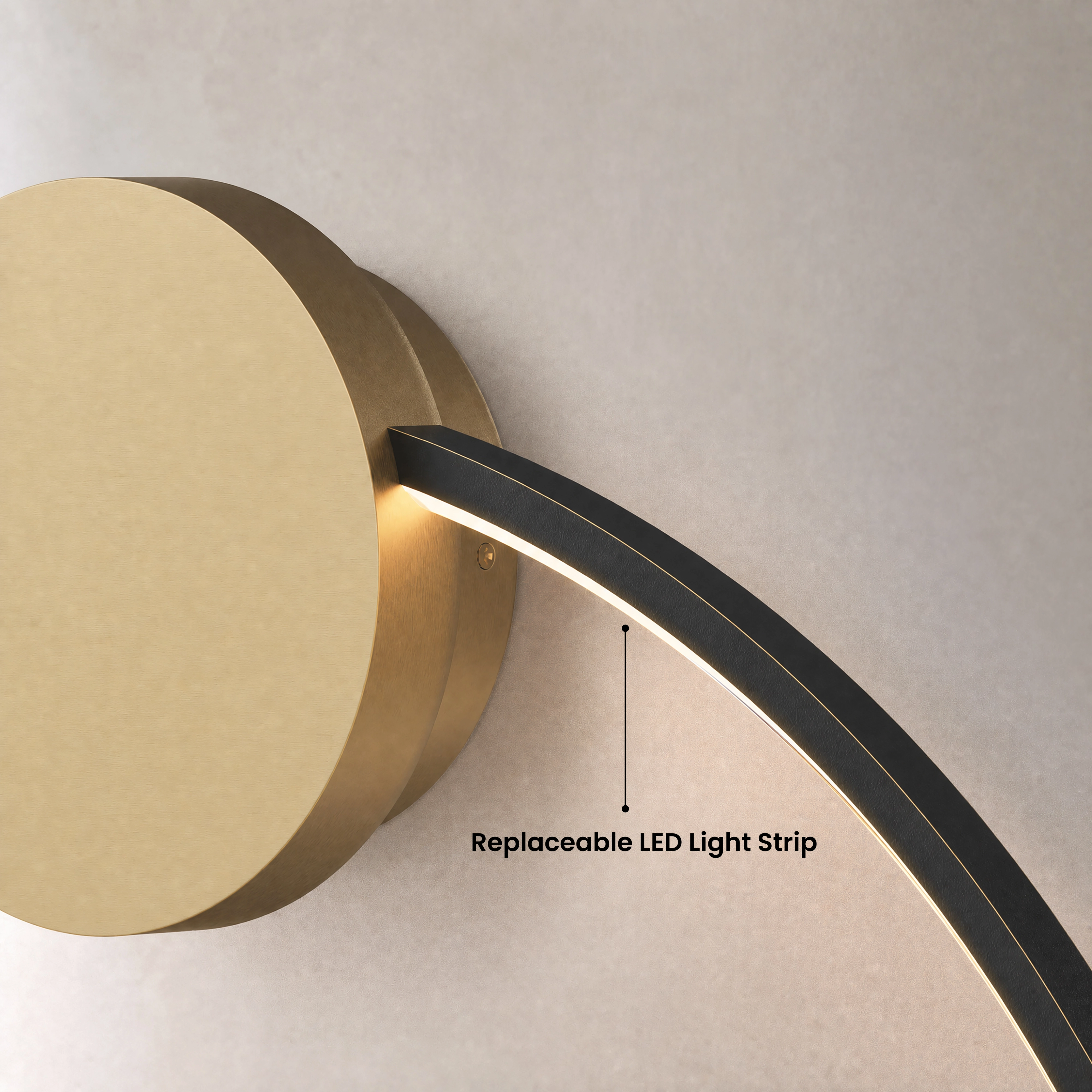 Halo wall lamp, gold ring lit warm white against a dark wall above a grey sofa in a living room