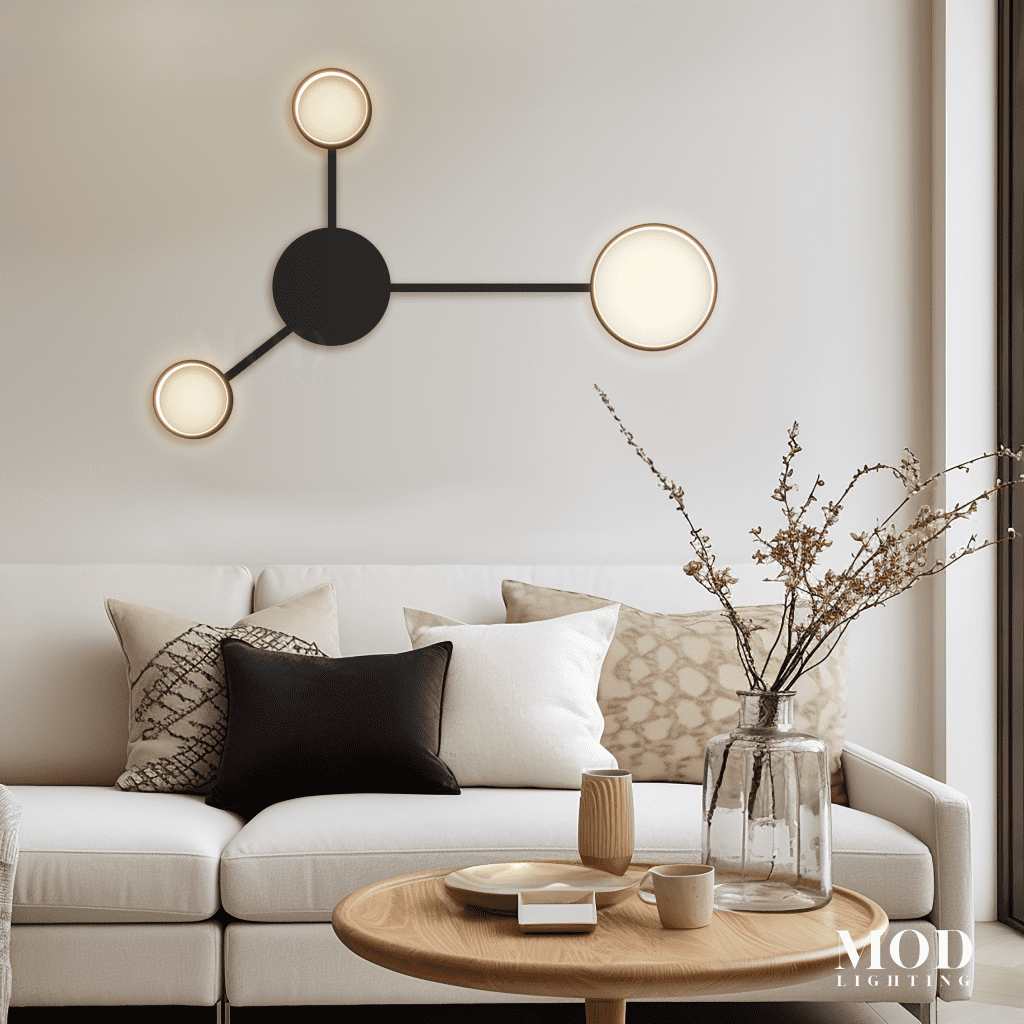 Link wall light, black bar with three round backlit discs, on a wall above a sofa
