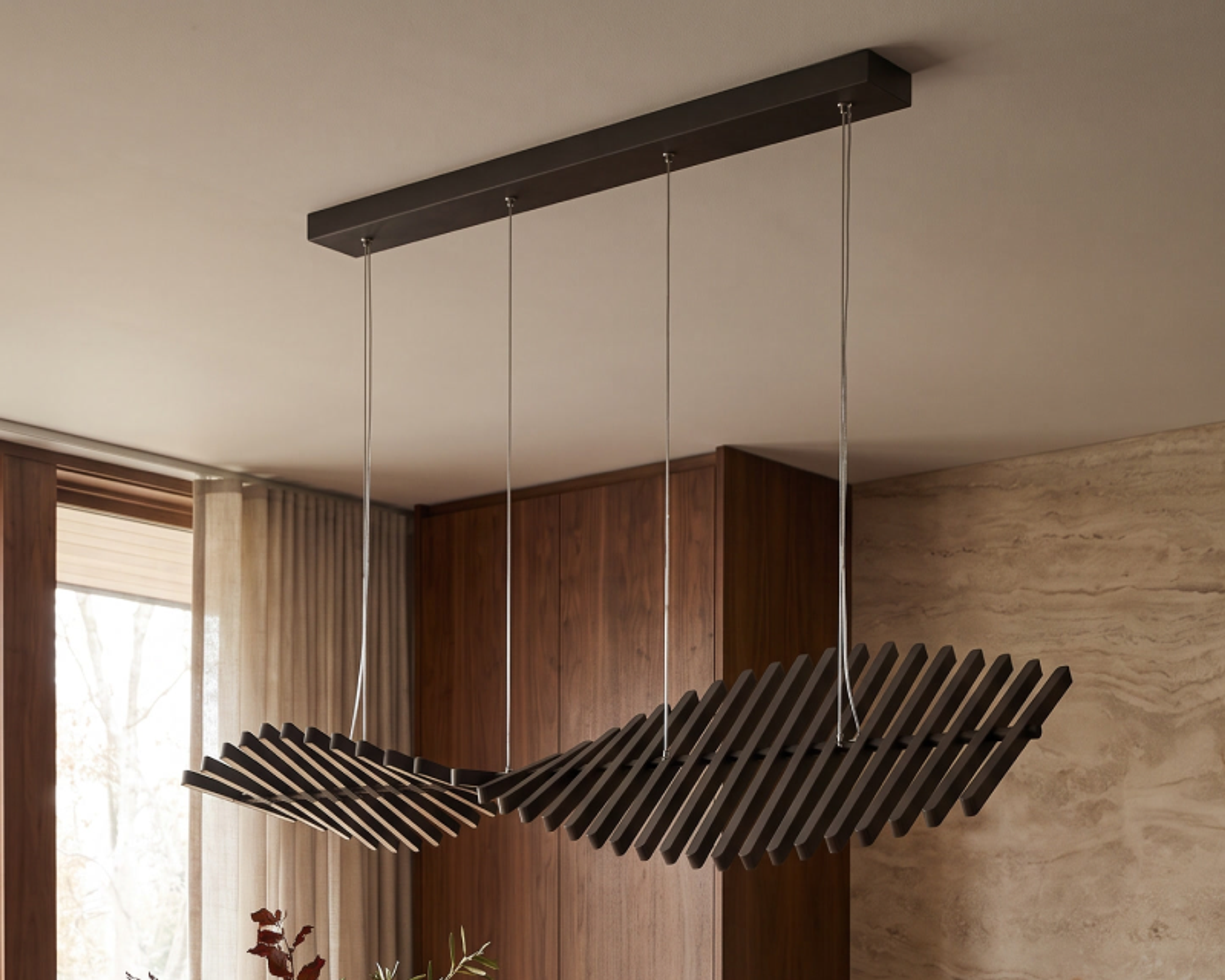 Finn, a linear chandelier, in a living room