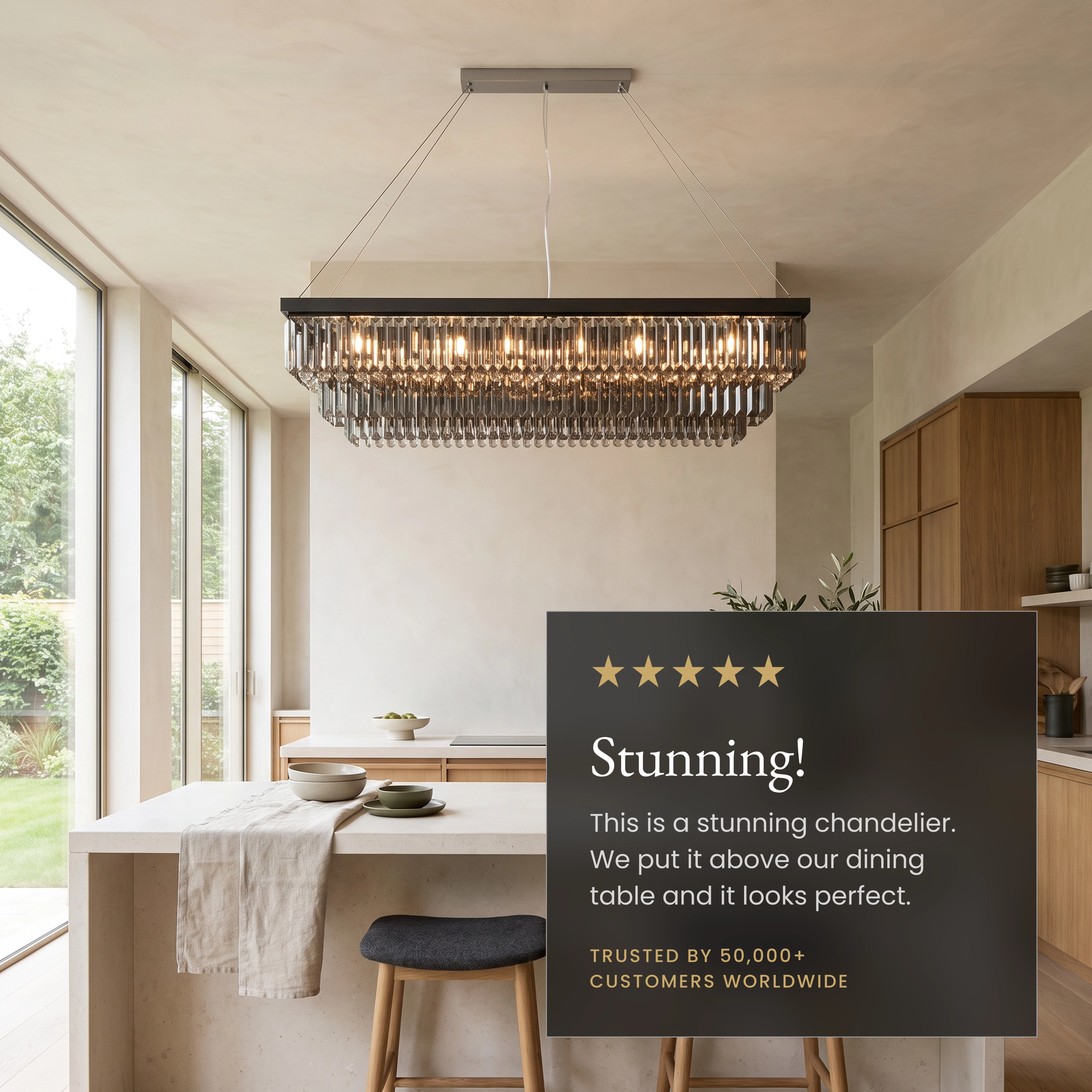 Umbra smoke-grey crystal chandelier over a sofa, labeling LED, crystal finish and stainless-steel features