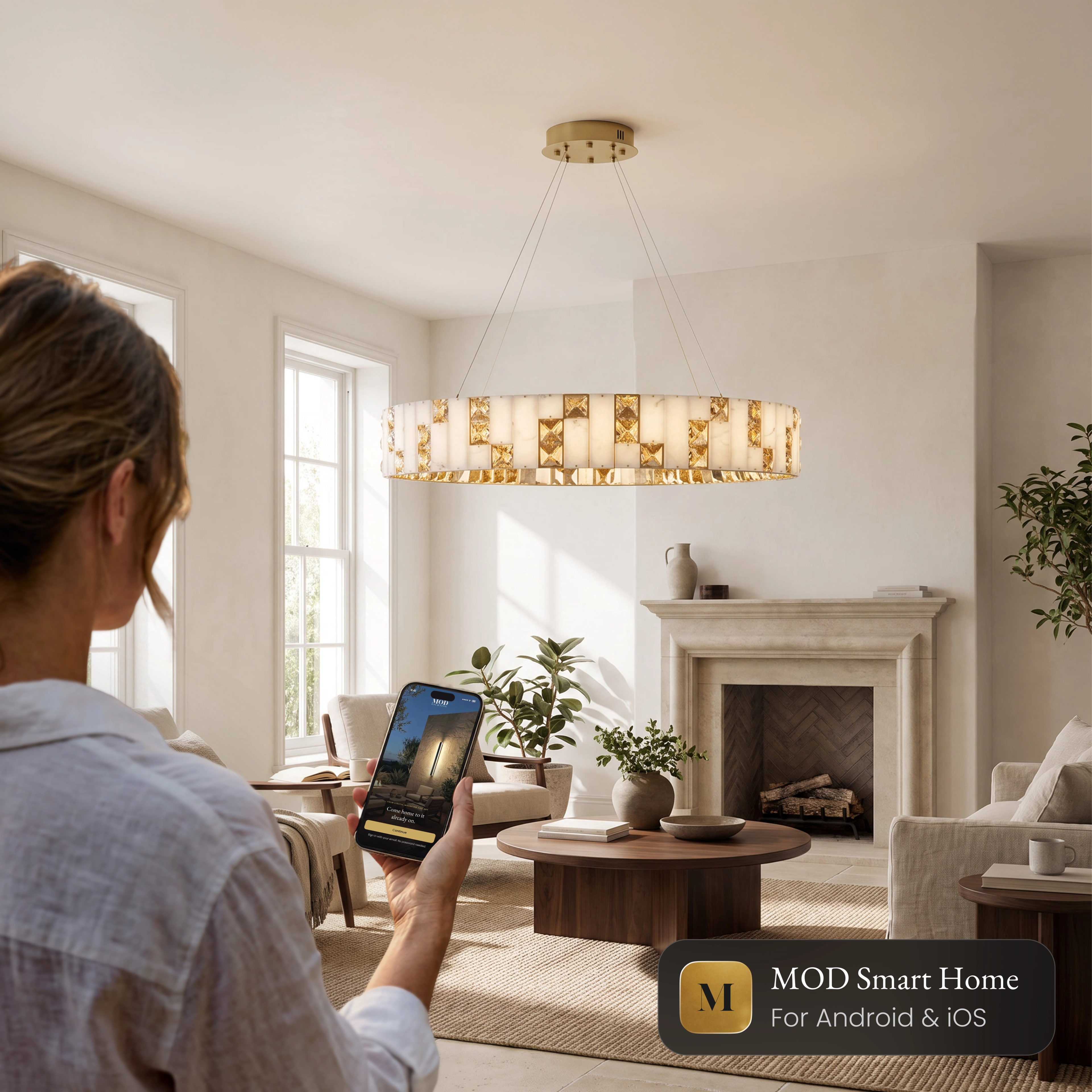 Seraphine Smart ring chandelier in a living room, controlled from the MOD Smart Home app on a phone