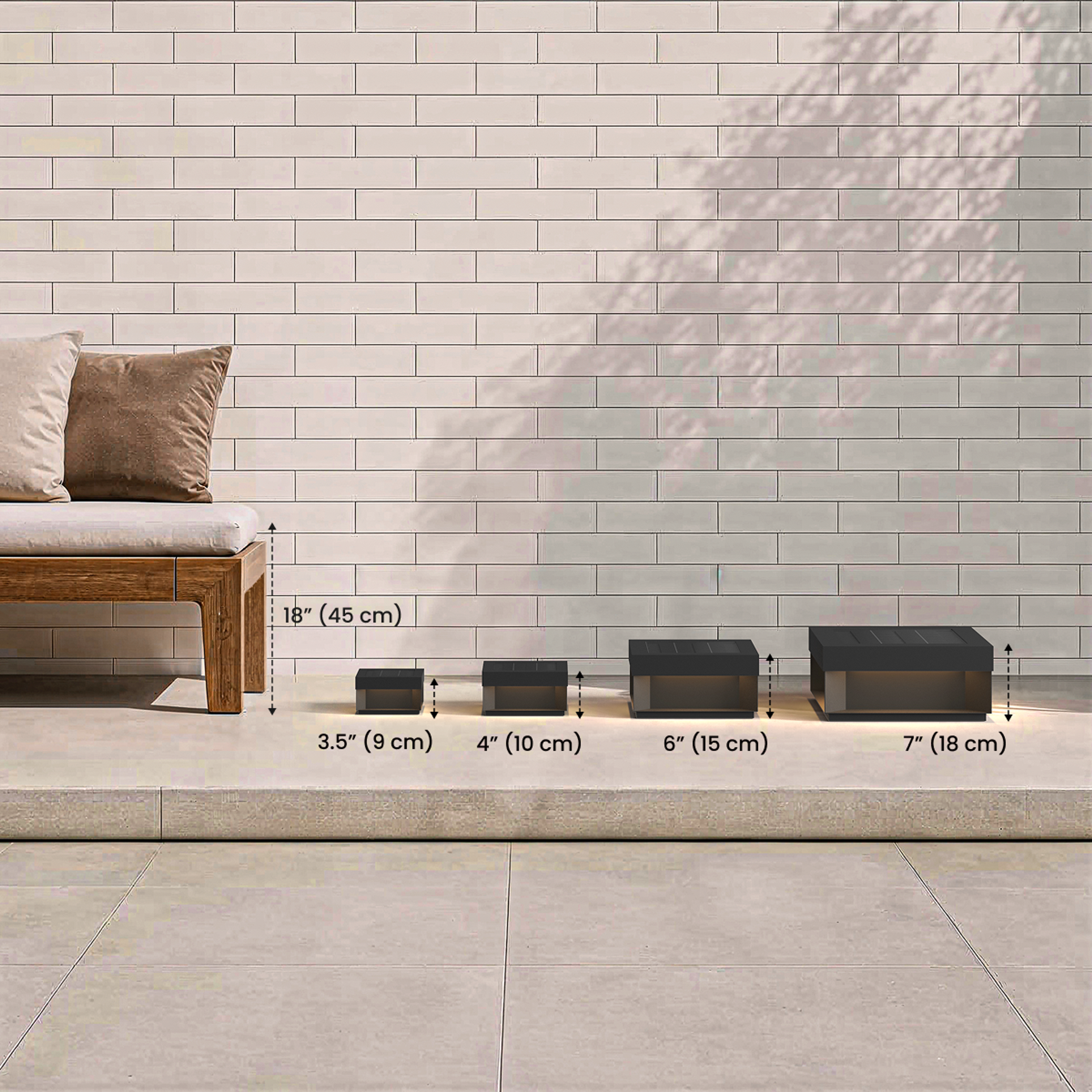 Chaz black solar outdoor lamp, four sizes: 3.5", 4", 6", 7" height, lined up against 18" sofa for scale
