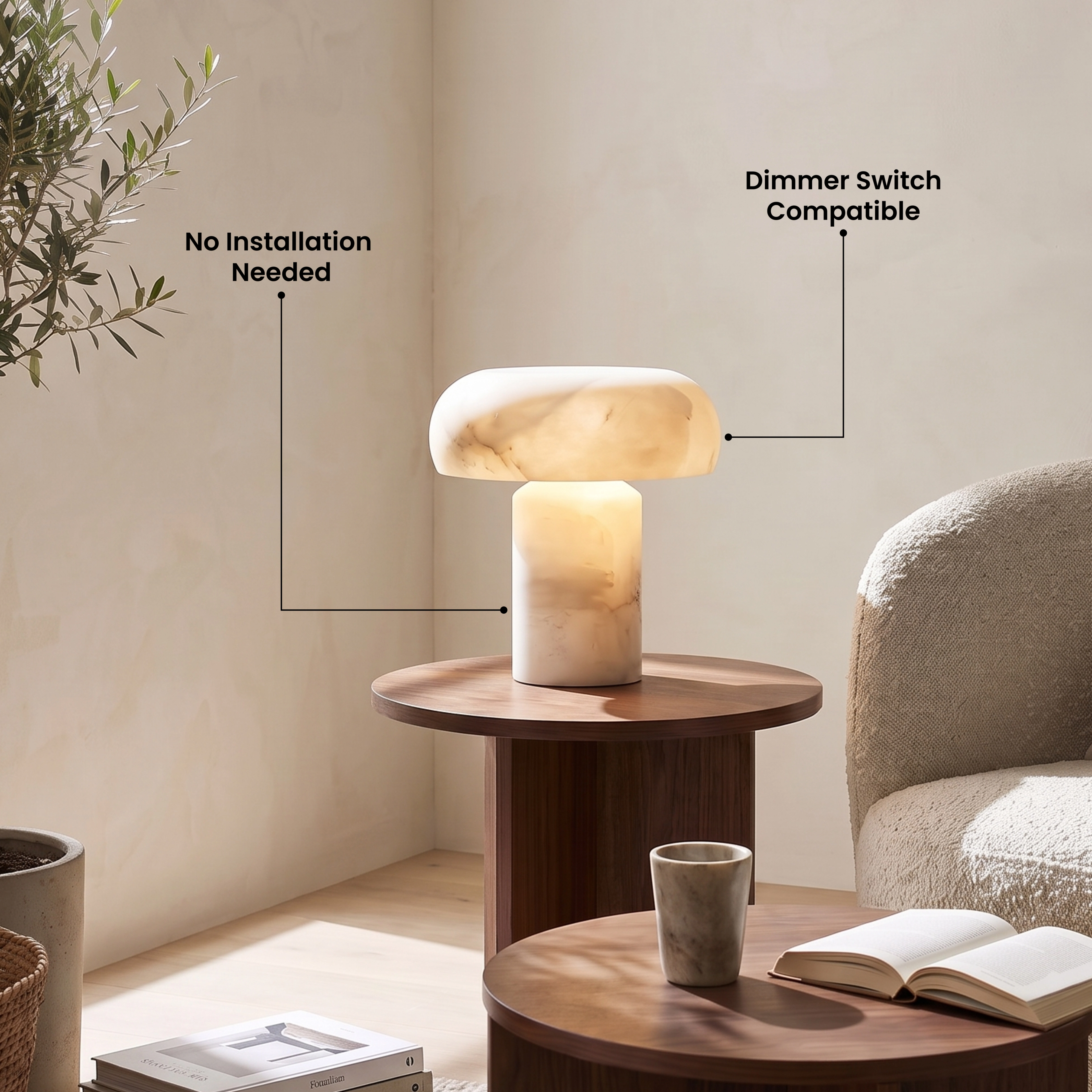 Ora Table Lamp, domed alabaster shade on a cylindrical stone base, lit on a bathroom shelf beside a basin